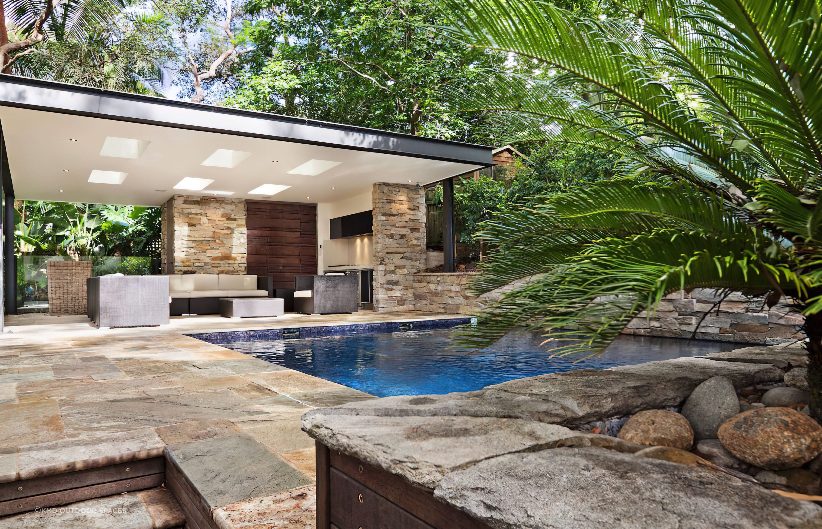 A stone wall can transform your pool into a lush natural feeling oasis. Featured project: Lindfield.