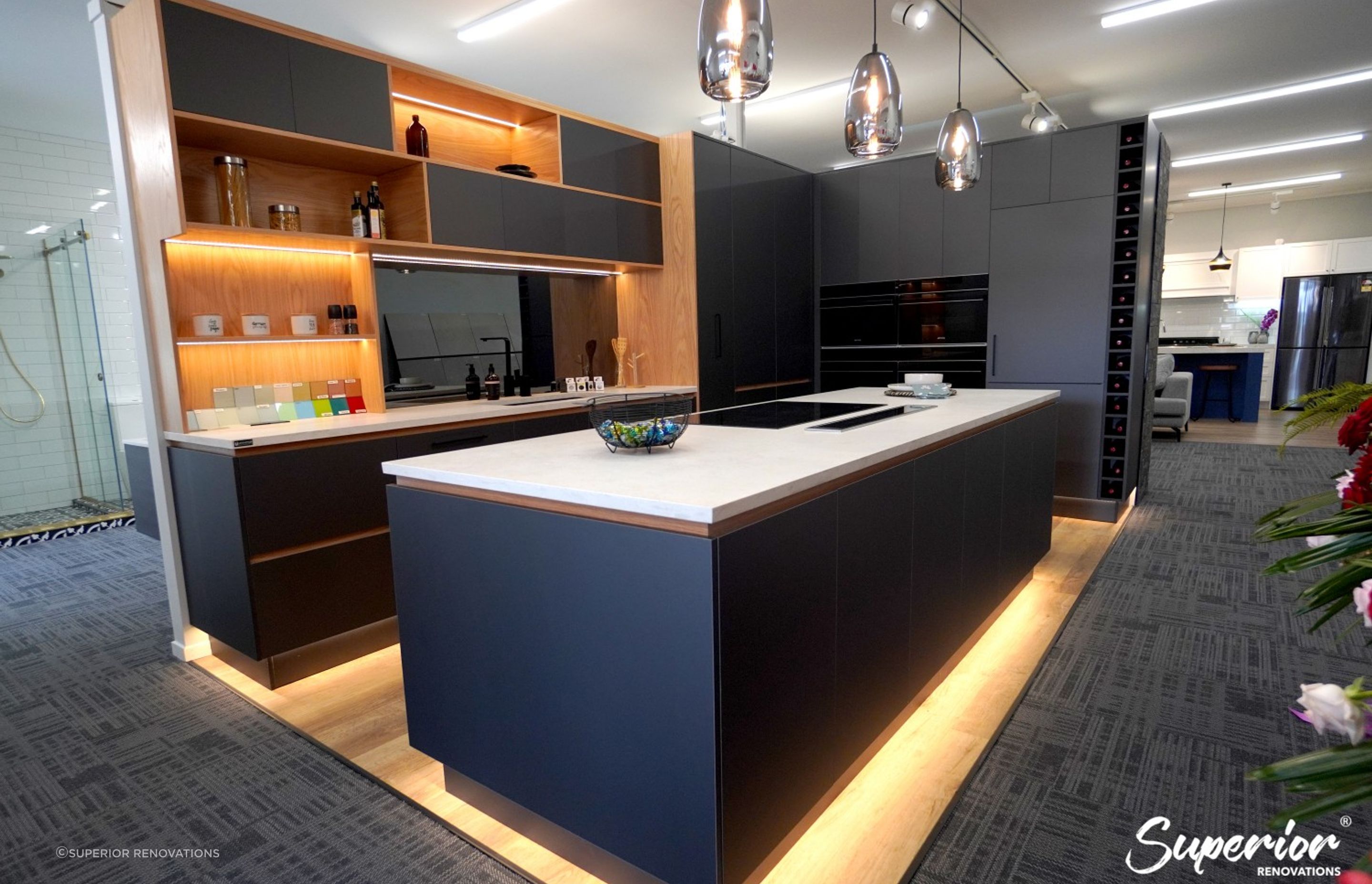 Our renovation showroom in Wairau Valley, Auckland. This is a great example of a modern and sleek kitchen which has storage on both sides of the kitchen island.