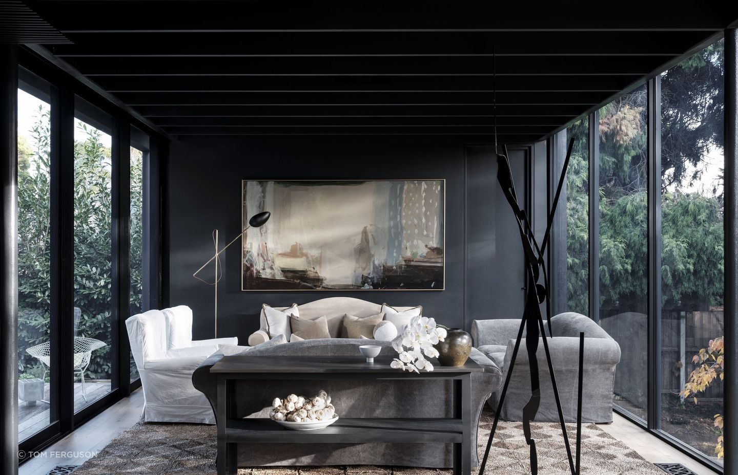 Peter Godwin’s 'Painter at Rest' hangs against a coal-black wall in the sitting room.