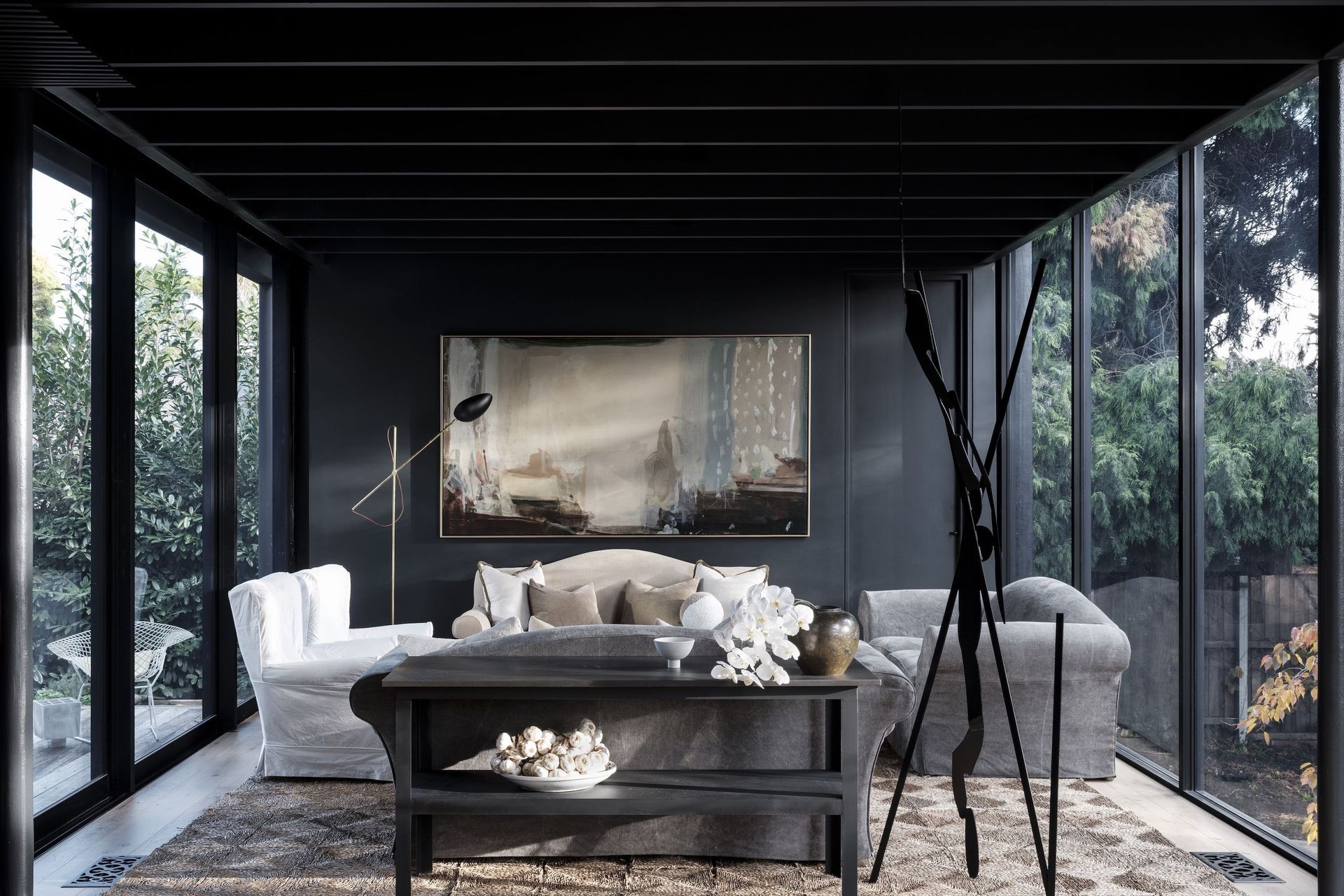 Peter Godwin’s 'Painter at Rest' hangs against a coal-black wall in the sitting room.