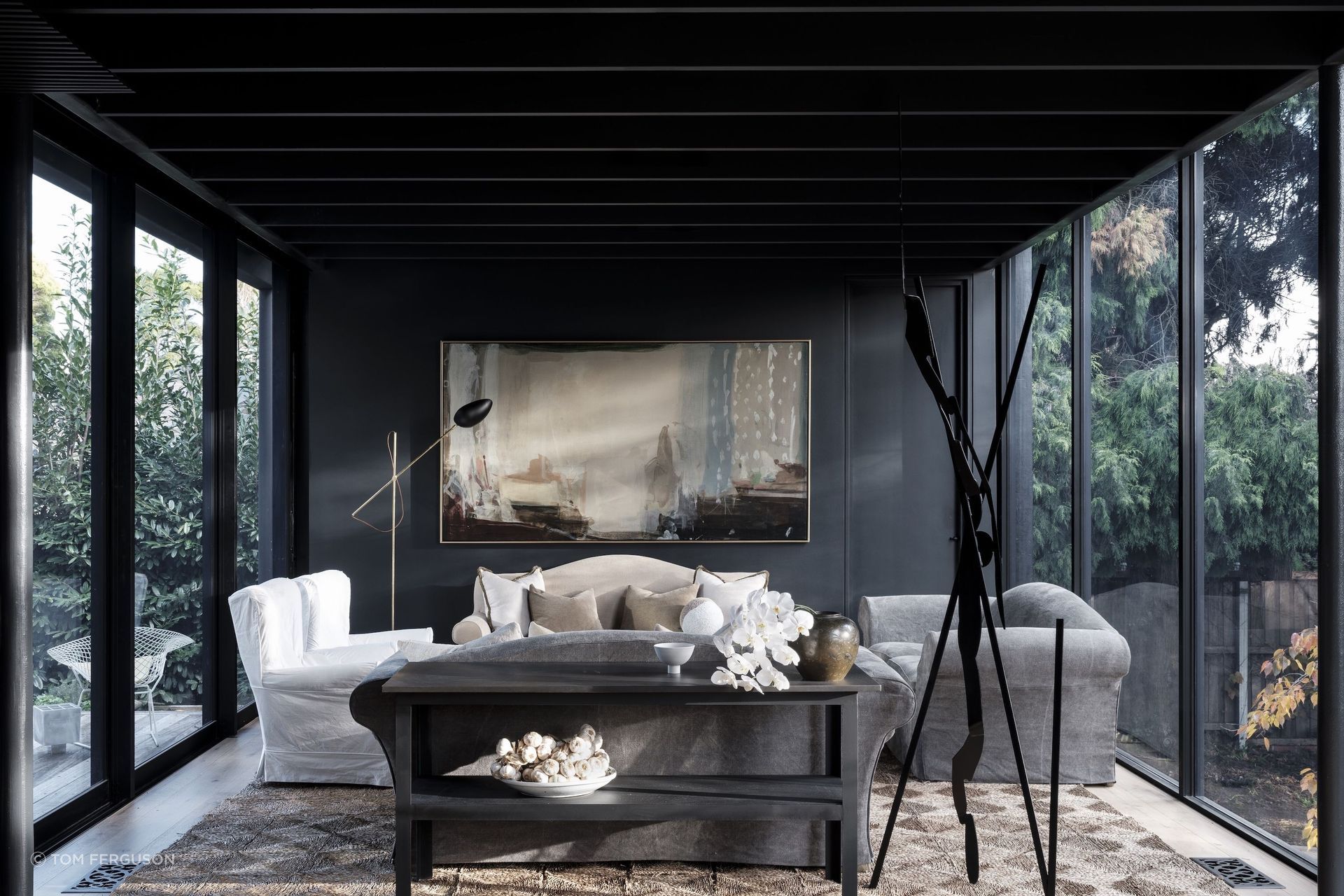 Peter Godwin’s 'Painter at Rest' hangs against a coal-black wall in the sitting room.