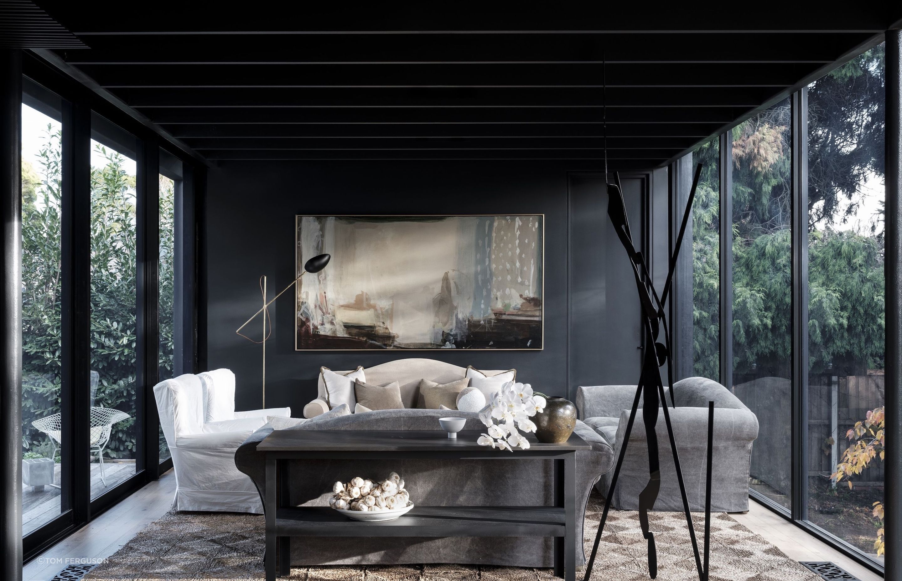 Peter Godwin’s 'Painter at Rest' hangs against a coal-black wall in the sitting room.