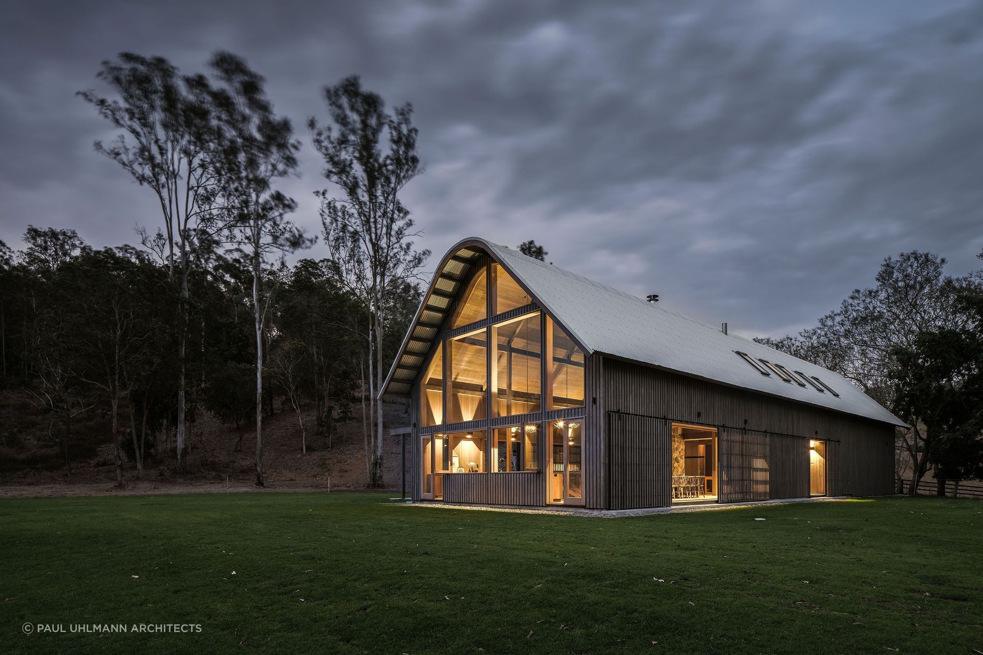 This beautiful barn style home features huge windows that let in plenty of natural light.  Photography by: Amy Macpherson Studio.