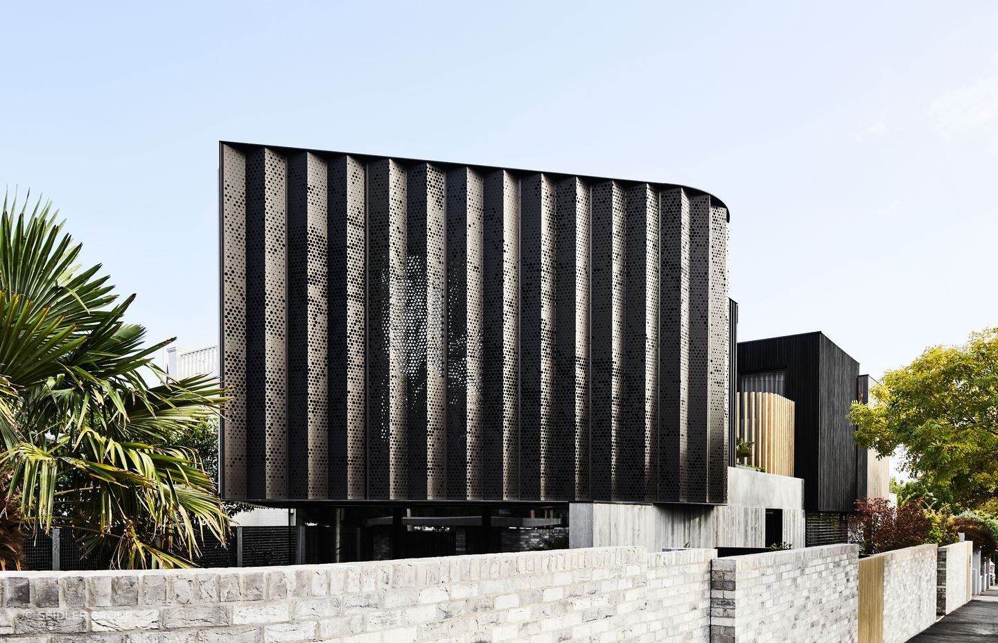 This architectural home stands out with its perforated aluminium cladding.