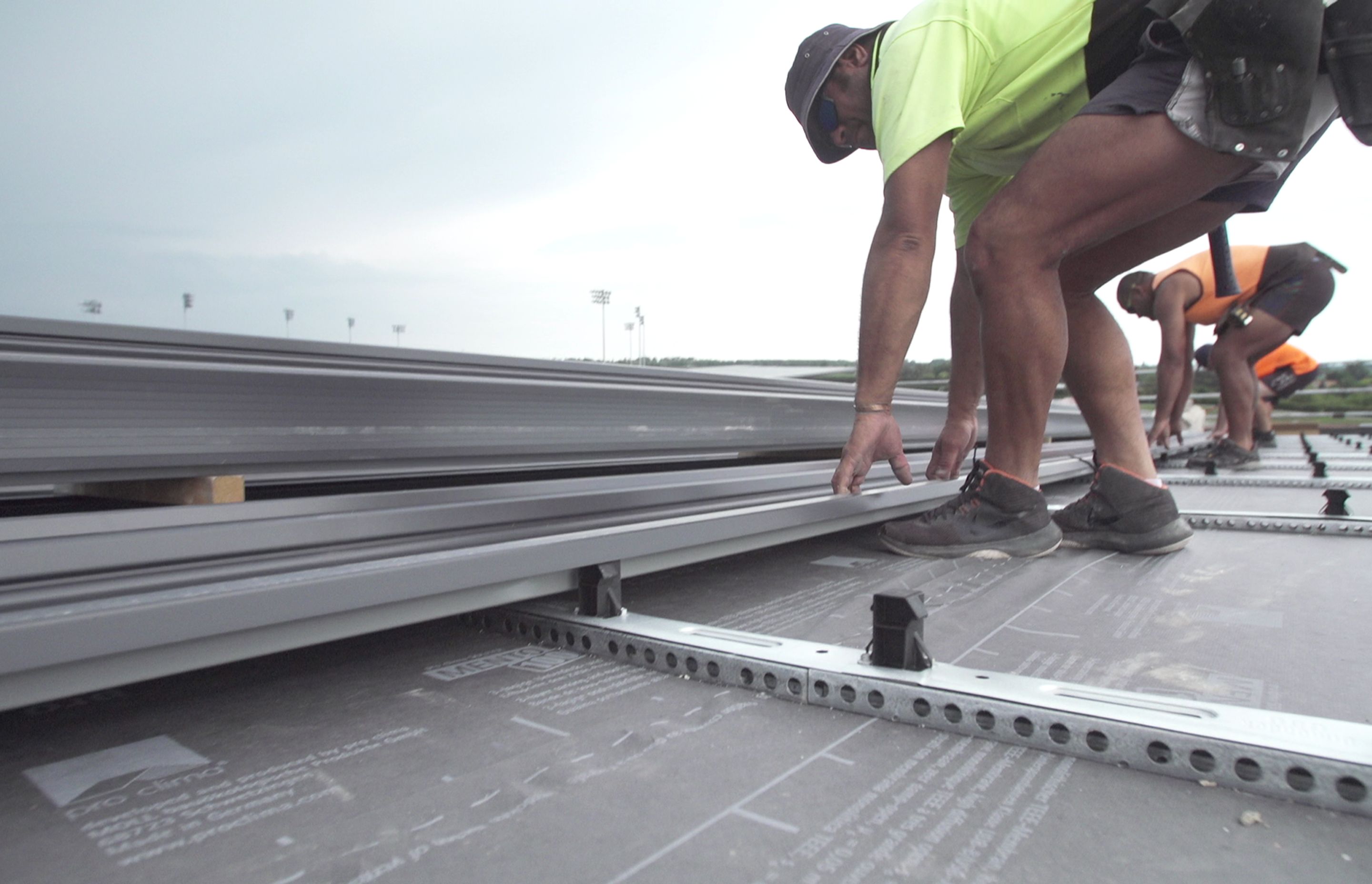 The perforated rail system creates an air space between the roofing sheet and the insulation board.
