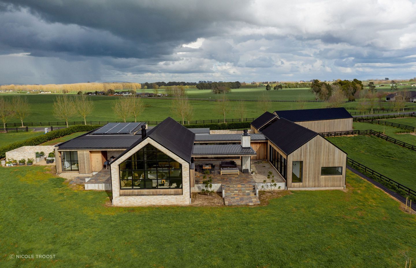 From above, the scattering of gable from buildings interconnected by almost flat pavilion forms echoes a rural architectural vernacular.