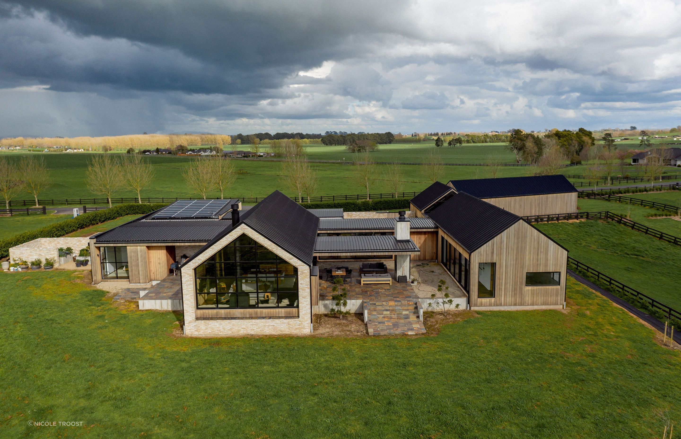 From above, the scattering of gable from buildings interconnected by almost flat pavilion forms echoes a rural architectural vernacular.