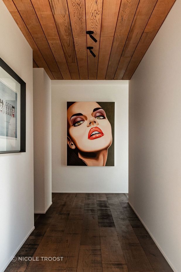 The hallway to the guest wing doubles as a gallery for the owners' art collection. The hallway to the guest wing doubles as a gallery for the owners' art collection.