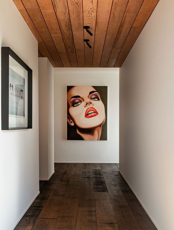 The hallway to the guest wing doubles as a gallery for the owners' art collection. The hallway to the guest wing doubles as a gallery for the owners' art collection.