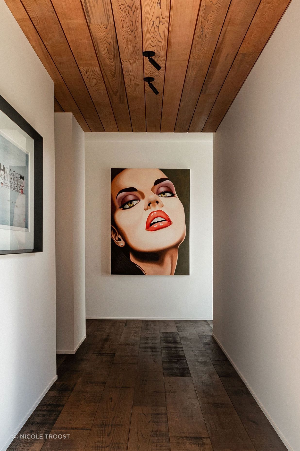 The hallway to the guest wing doubles as a gallery for the owners' art collection. The hallway to the guest wing doubles as a gallery for the owners' art collection.