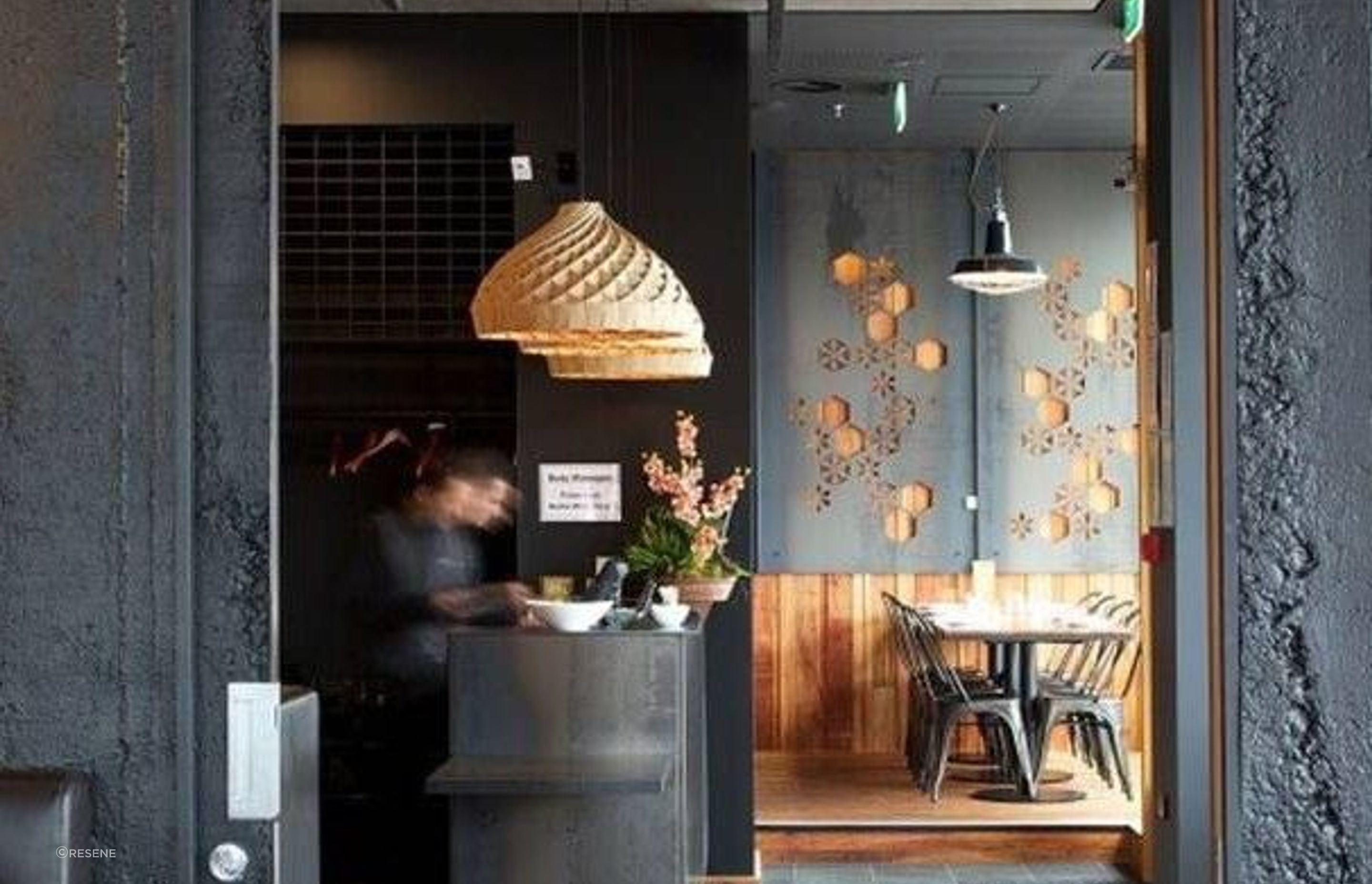 Spice Paragon Restaurant in Christchurch features Muros Grey Roughcast Concrete wall panels installed vertically and painted in Resene All Black. Design by Crafted.
