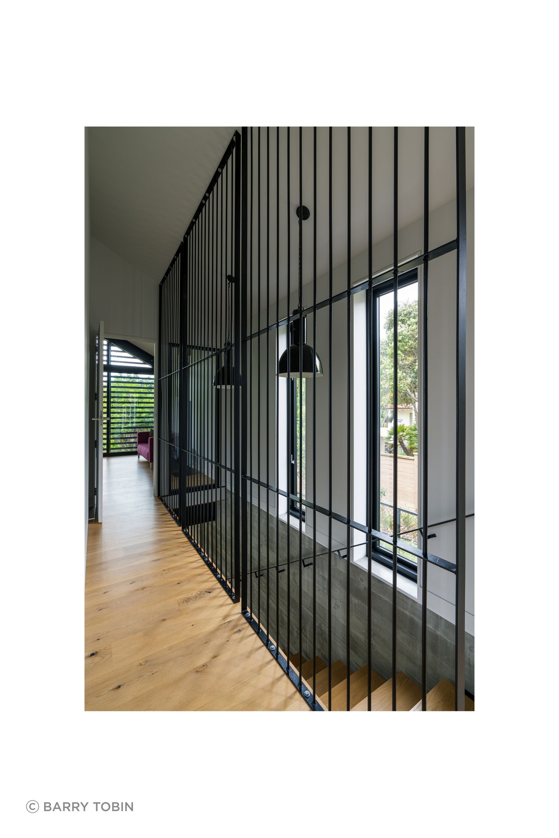 Clive wanted to separate the stairwell but not put in a solid wall. He considered black netting before trying the metal rods, framing them into panels to stop them flexing. “It was an aesthetic that just developed, and met my design idea to keep the hallway as open as possible.”