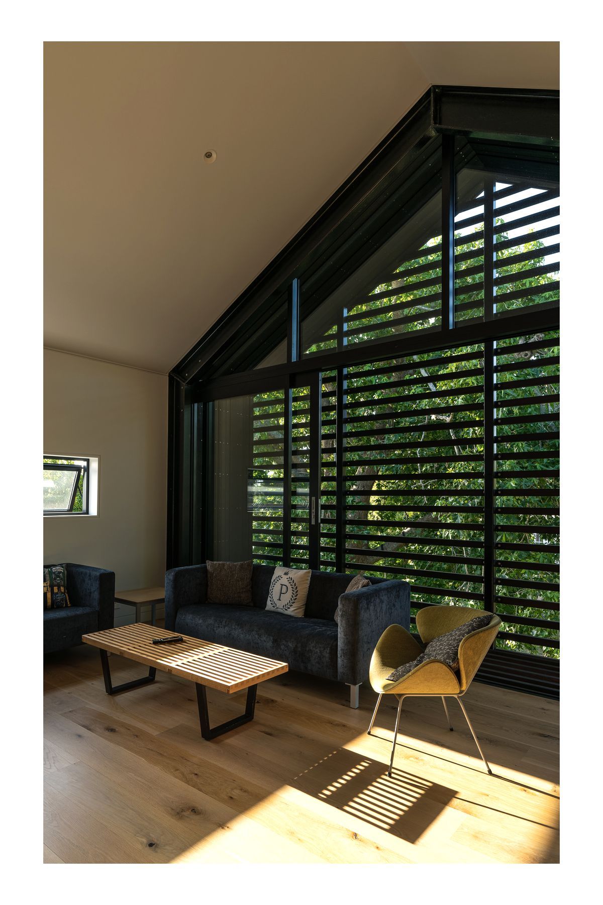 The upstairs living room is very useful with teenage children. “The kids tend to use it when they have friends over. In the summertime the large sliding windows can be left open to ventilate the house. We can leave it open without any security issues because it has the slats across it, which also double as sun control.”