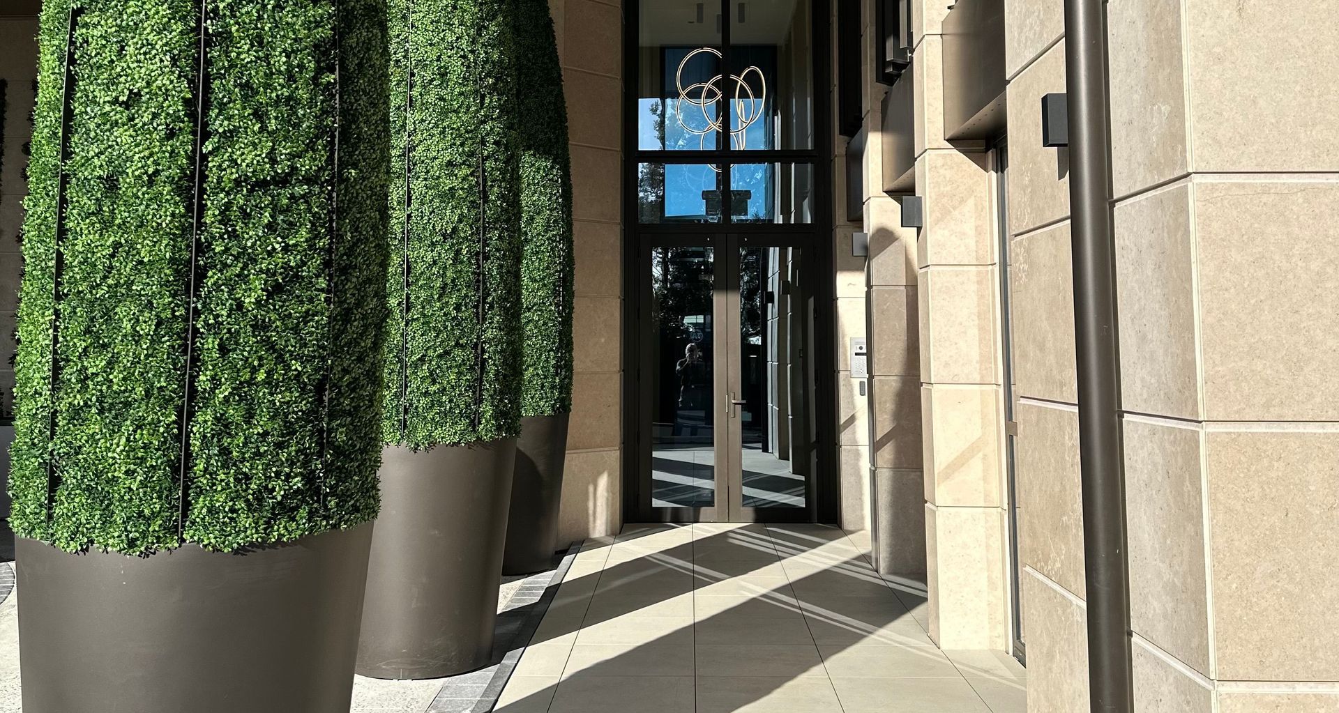 The developers custom designed "bullet planters" greet residents and guests.