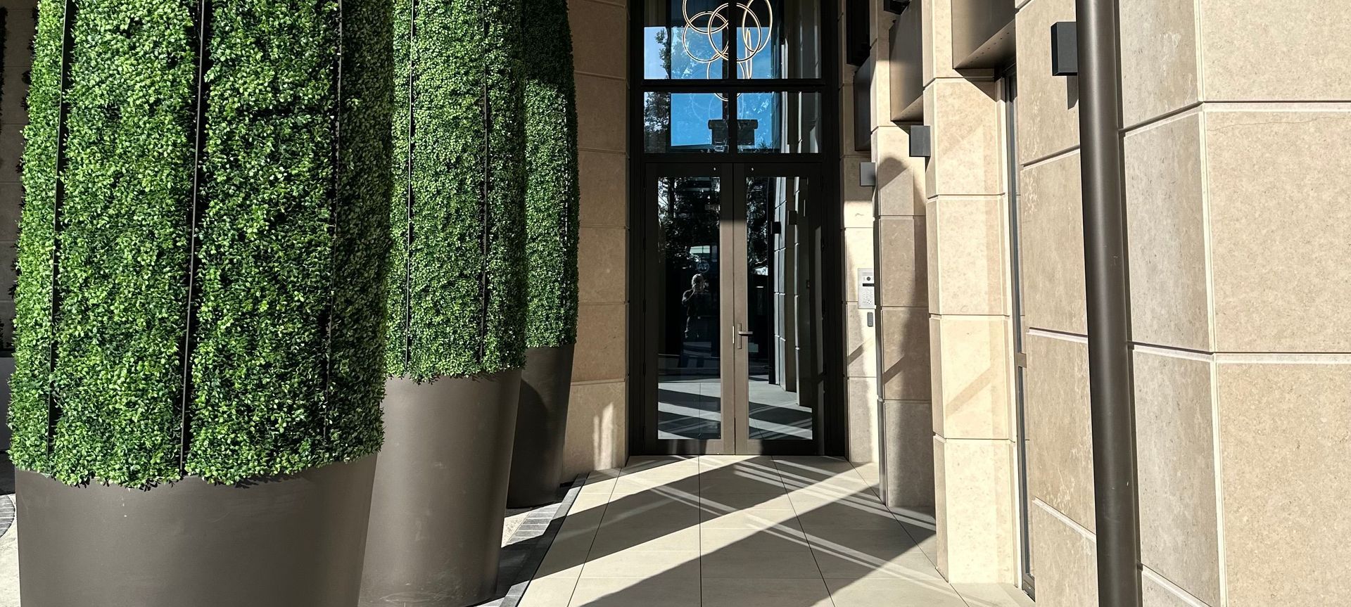 The developers custom designed "bullet planters" greet residents and guests.