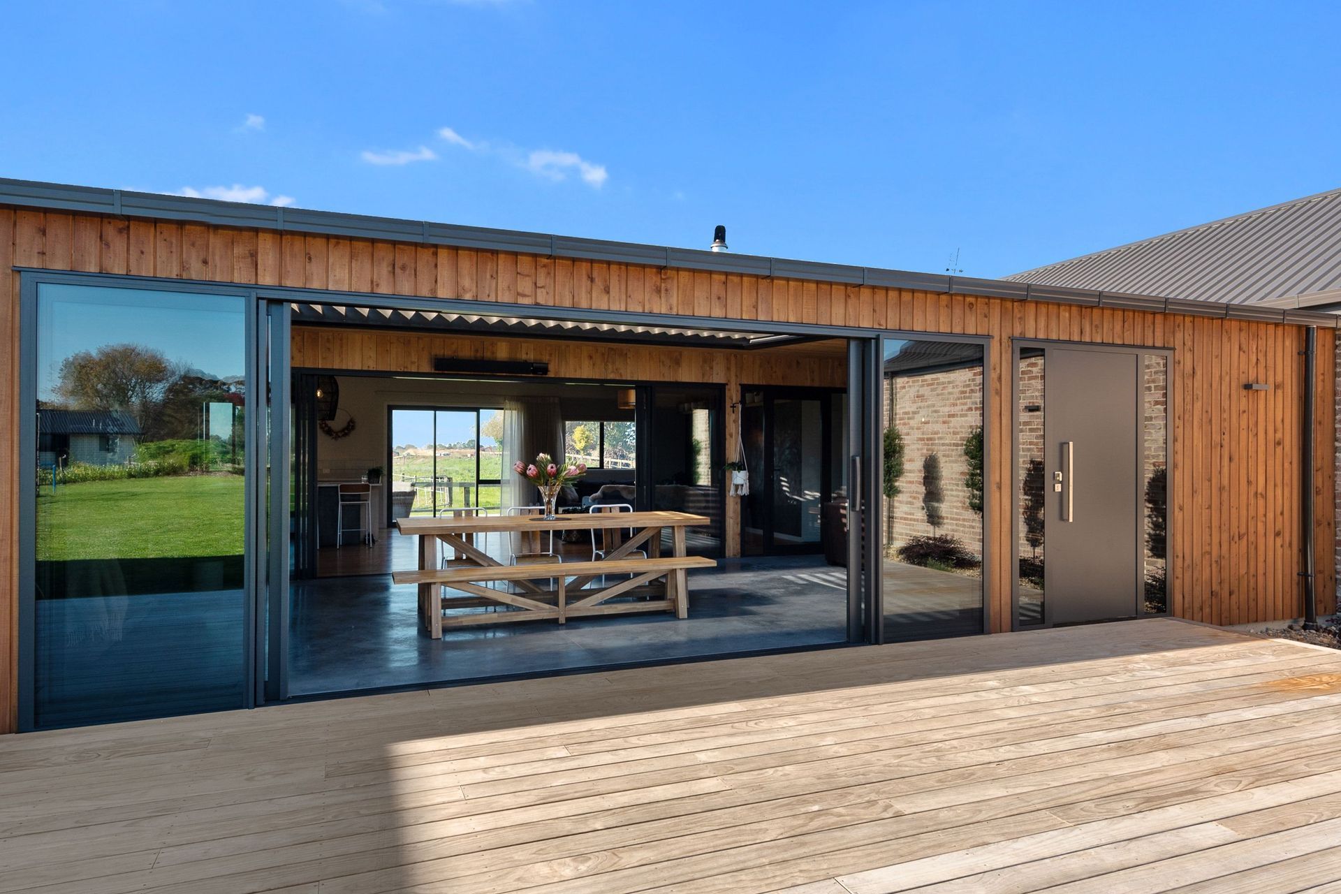 Large sliding doors feature on both sides of the courtyard. “You create that sense of space, where you're looking right through your house,” says Rob. The front door is mirrored by another door on the second set of sliders, for a choice of access points.