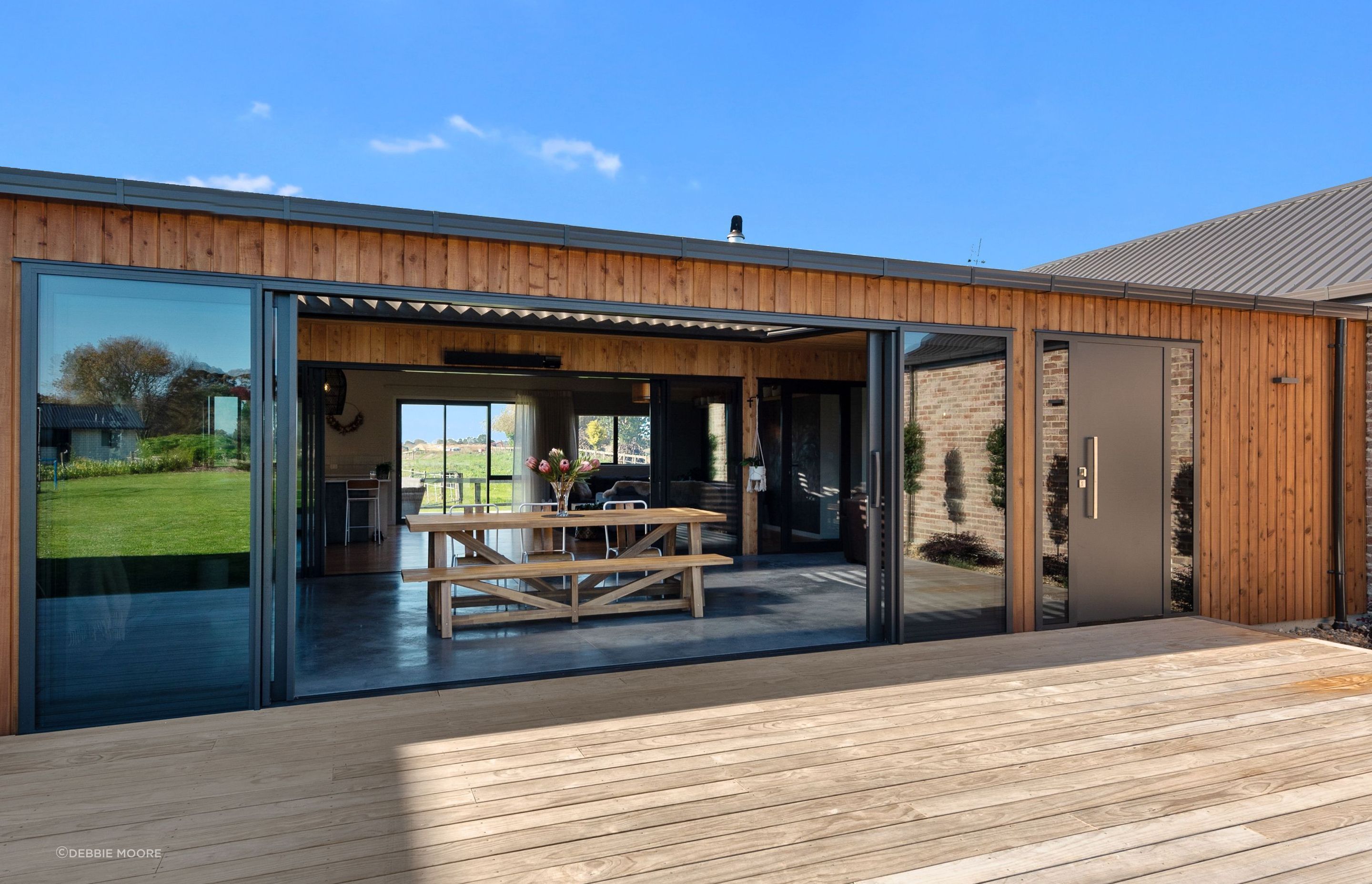 Large sliding doors feature on both sides of the courtyard. “You create that sense of space, where you're looking right through your house,” says Rob. The front door is mirrored by another door on the second set of sliders, for a choice of access points.