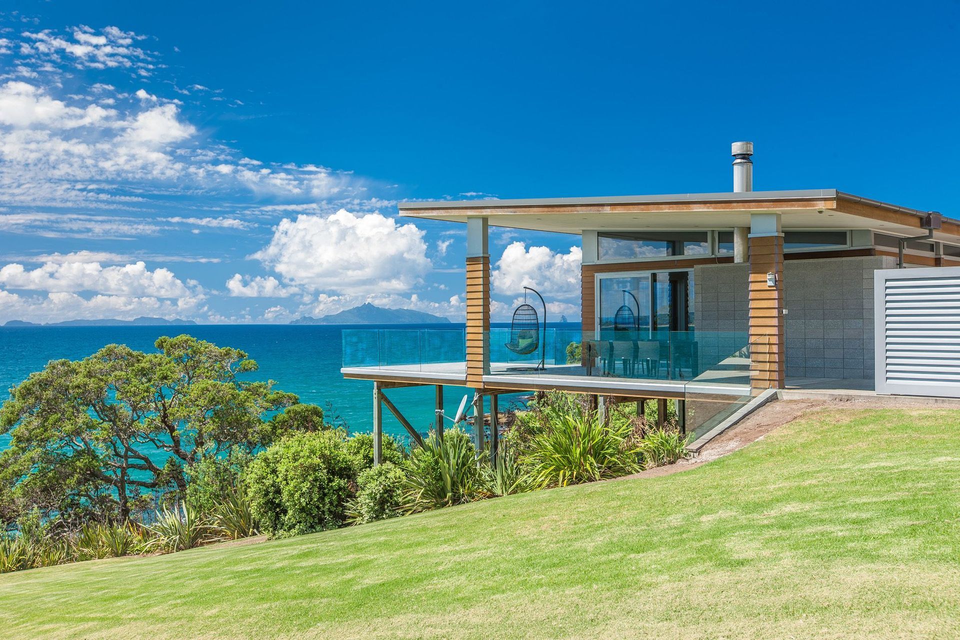Waipu Cove house by Hoxha Bailey Architects is an exploration of regional modernism, refuge and a critical response to topography.