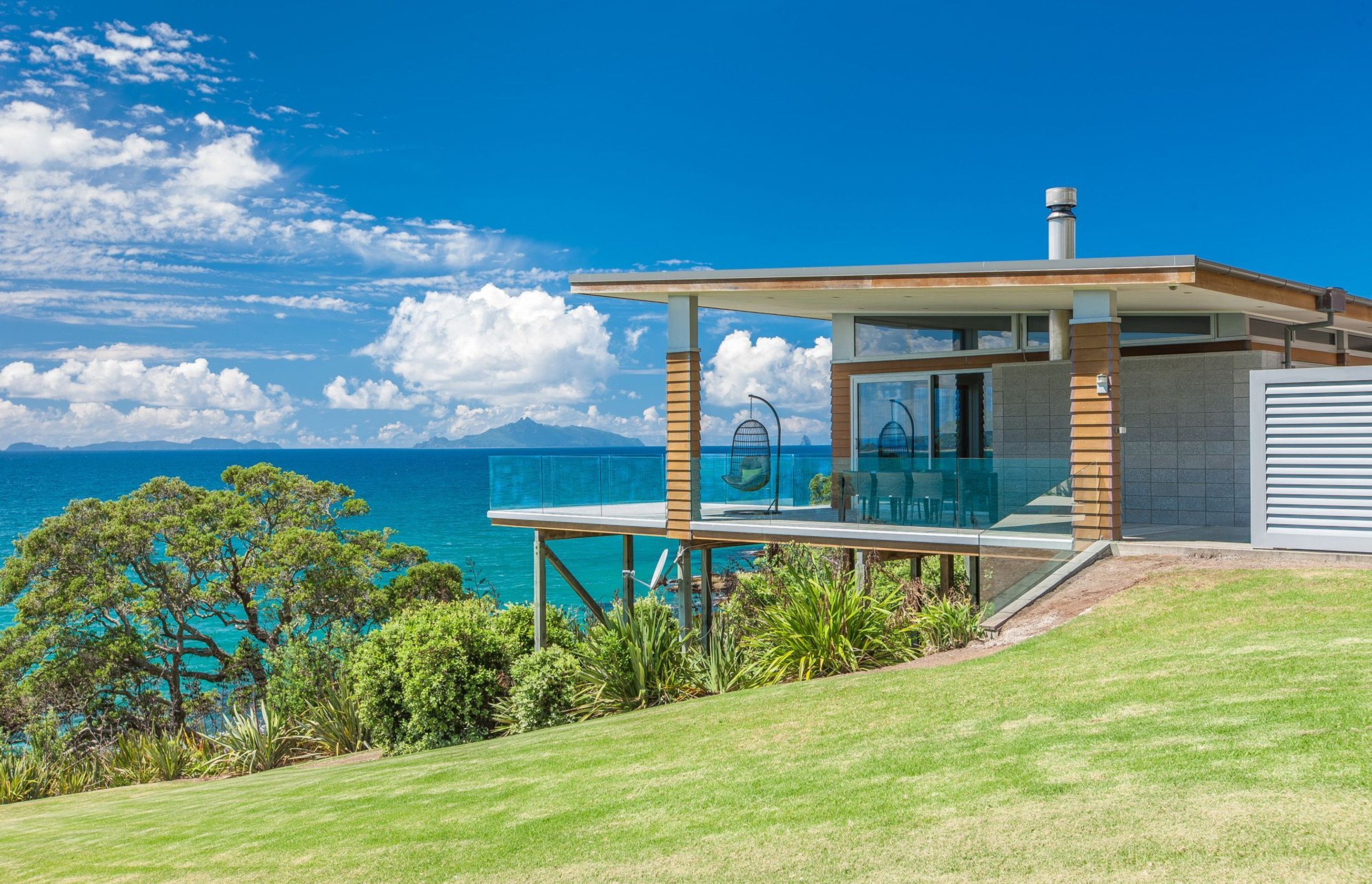 Waipu Cove house by Hoxha Bailey Architects is an exploration of regional modernism, refuge and a critical response to topography.