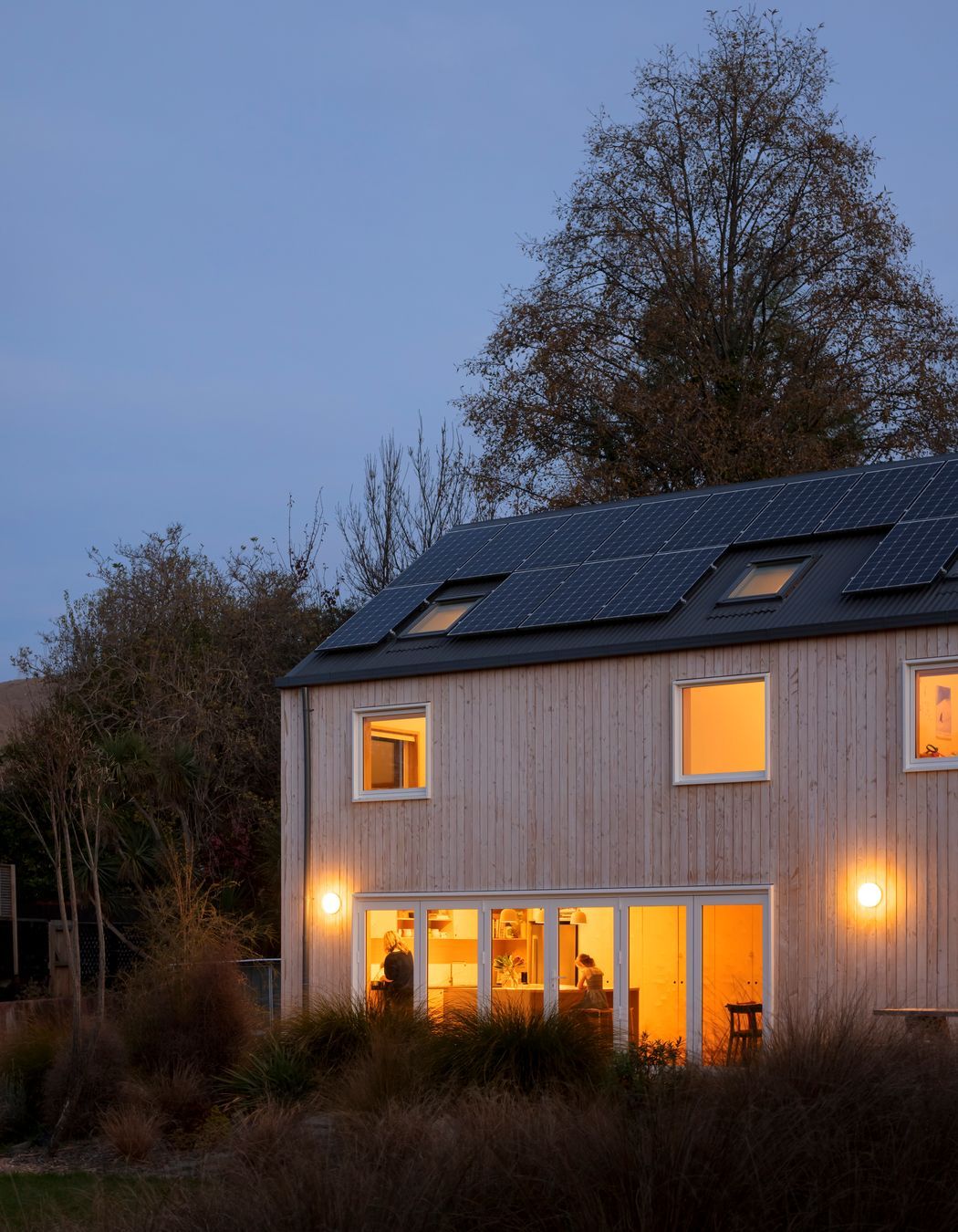 Solar panels line the roof, providing renewable energy to the family home.