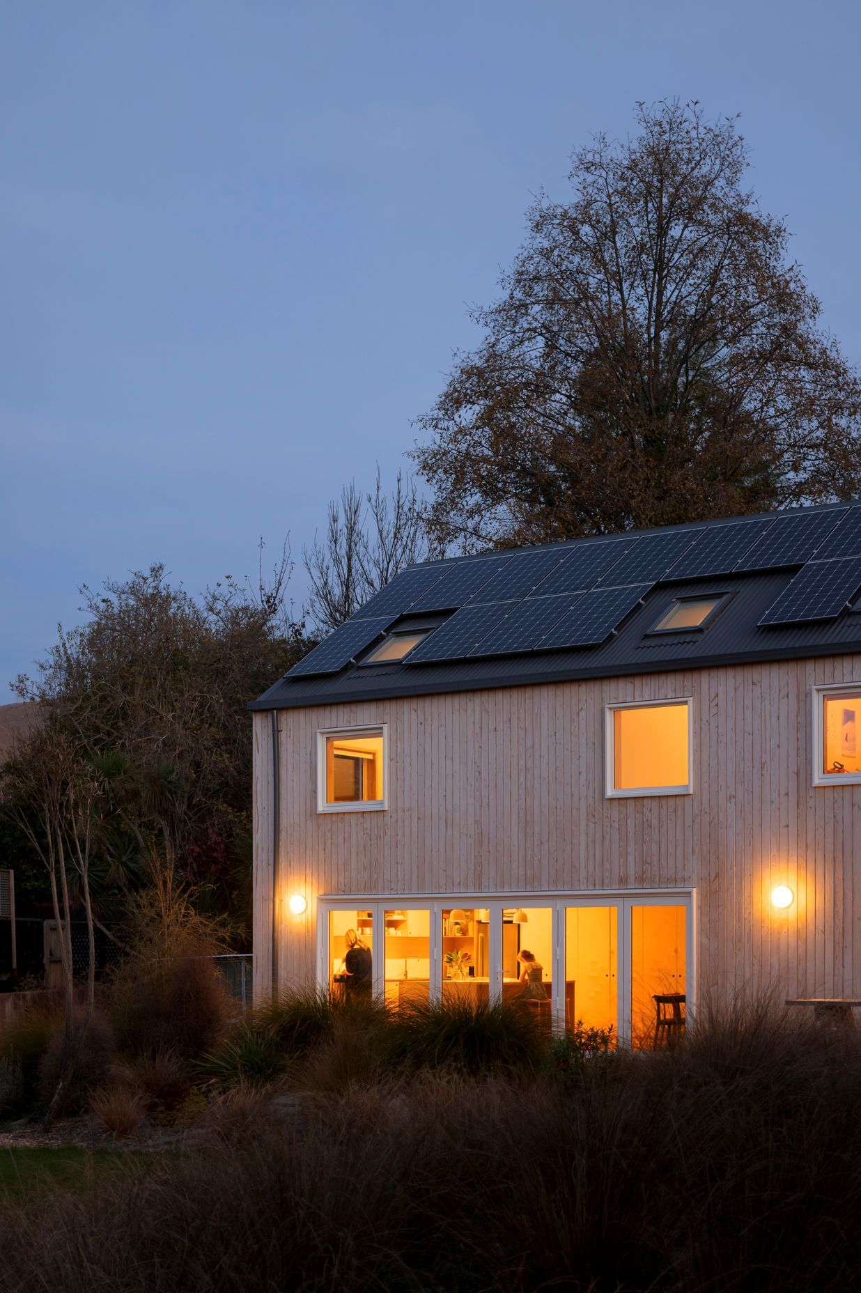 Solar panels line the roof, providing renewable energy to the family home.