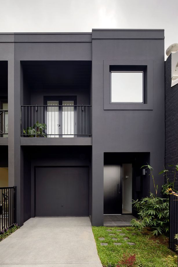 An exquisite black painted exterior, paired with black window frames. Photography by Tatjana Plitt.