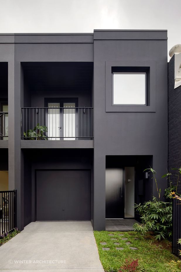An exquisite black painted exterior, paired with black window frames. Photography by Tatjana Plitt.