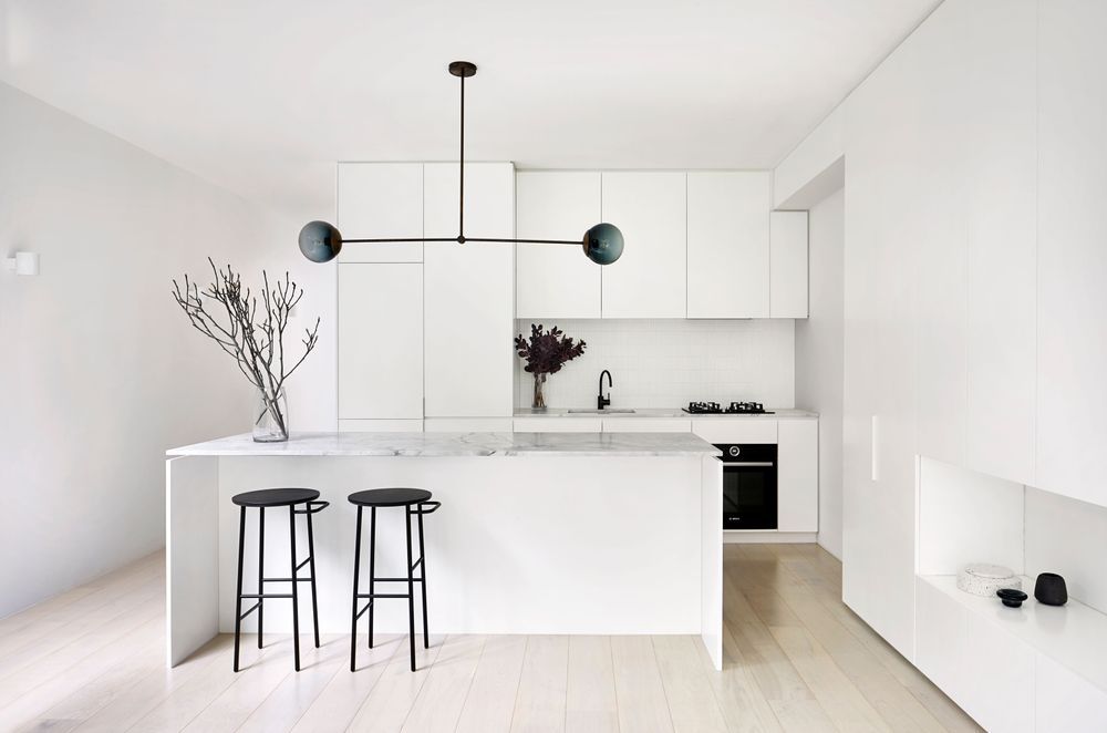 The kitchen embodies a sleek and minimalist aesthetic. Photography by Tatjana Plitt.