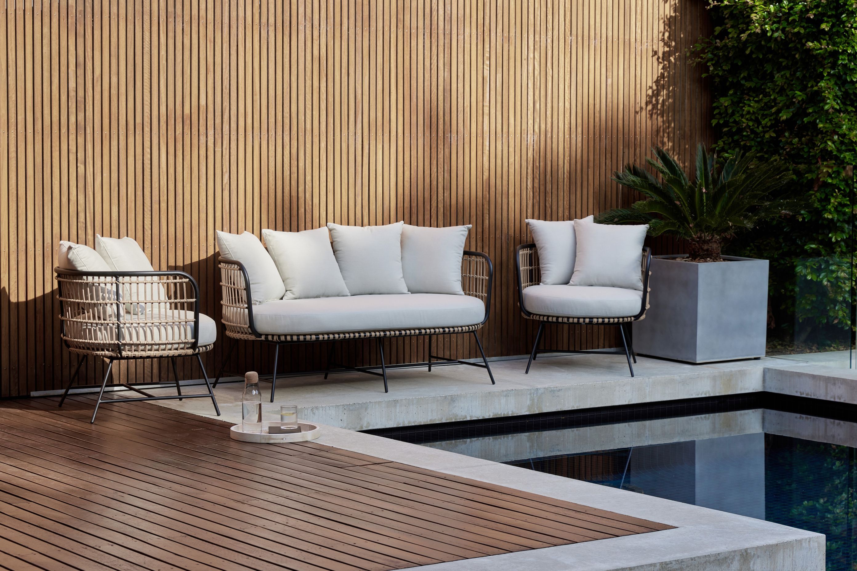 This Arden bamboo wicker outdoor lounge set is wrapped in bamboo wicker.