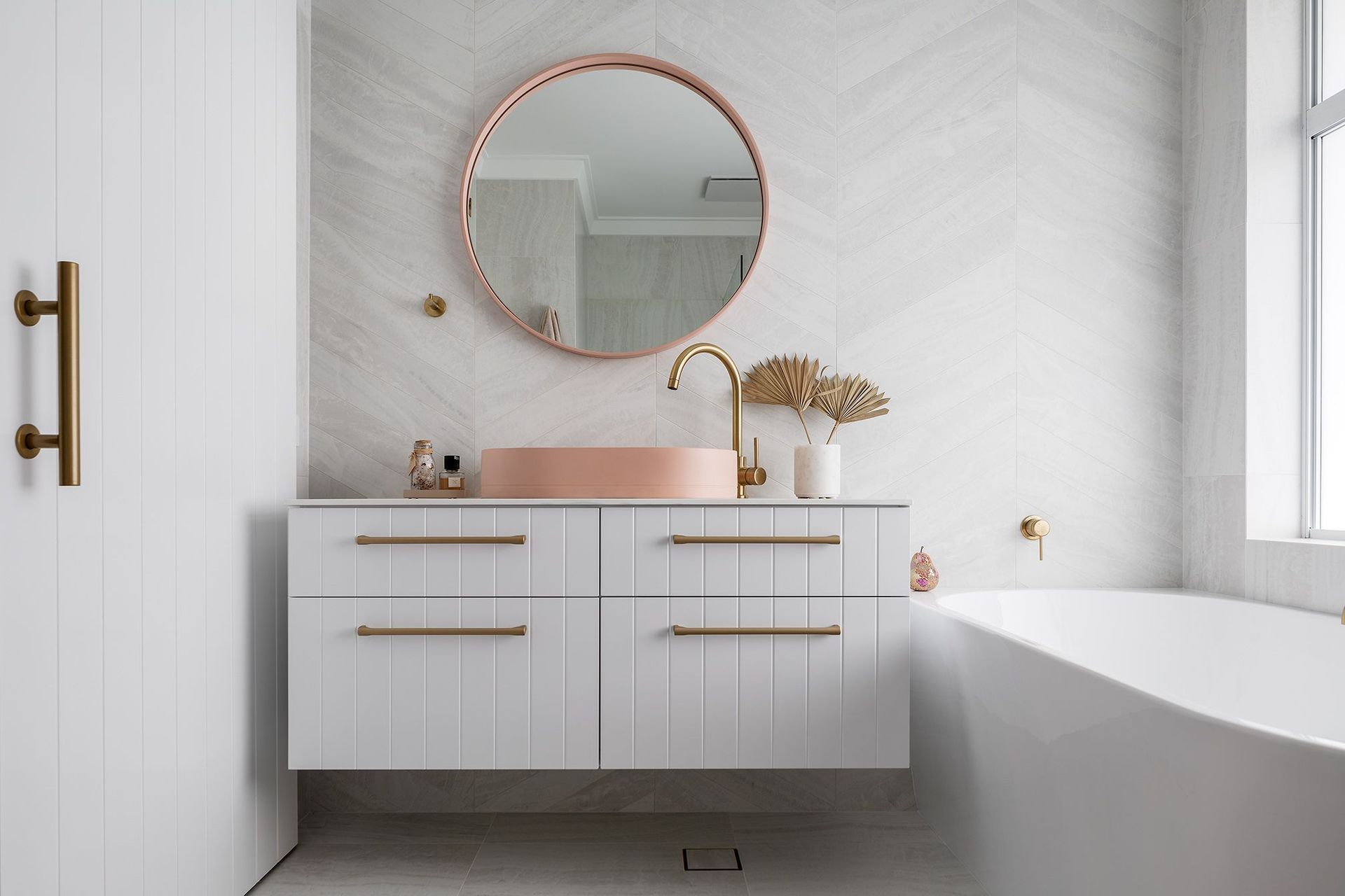 Matching the material and style of your bathroom mirror and sink creates a uniform look. Featured project: Sholl Project - Bathroom