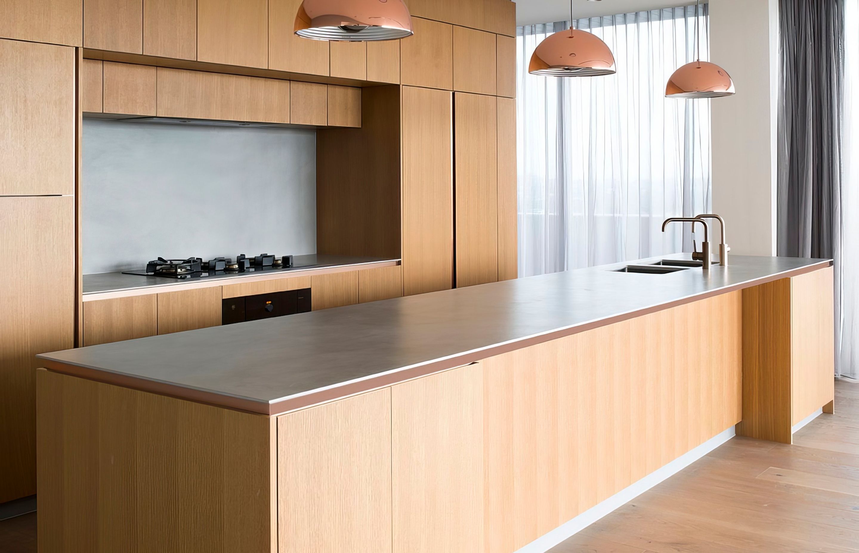 MAXIMUM porcelain panels in Argento 12mm to kitchen island, benchtop and splashback. Magnus Apartments by Cottee Parker
