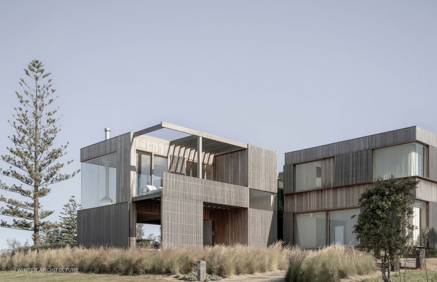Bermagui Beach House's large glass windows and weathered cladding reflect a peaceful, almost meditative rapport with the environment. Photography: Jack Mounsey
