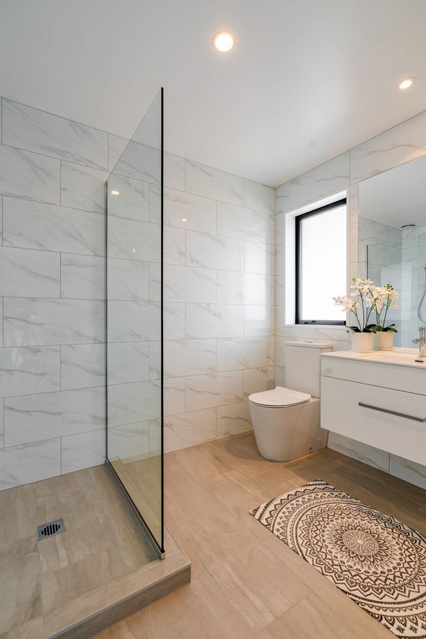 The client decided on a tiled shower after the foundation was poured in this ensuite bathroom, so Bird Built installed a shower hob.