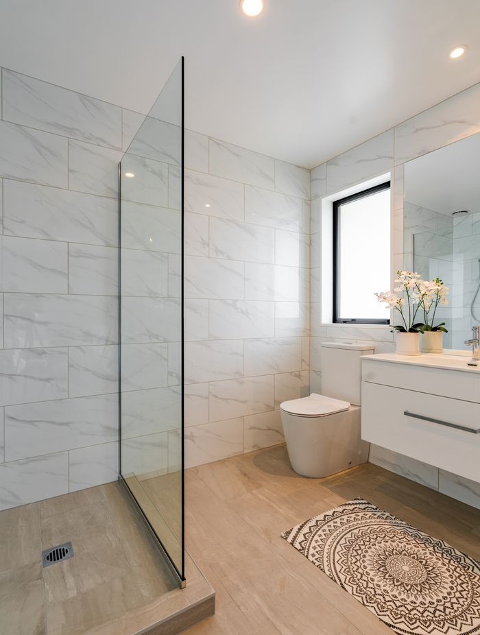 The client decided on a tiled shower after the foundation was poured in this ensuite bathroom, so Bird Built installed a shower hob.