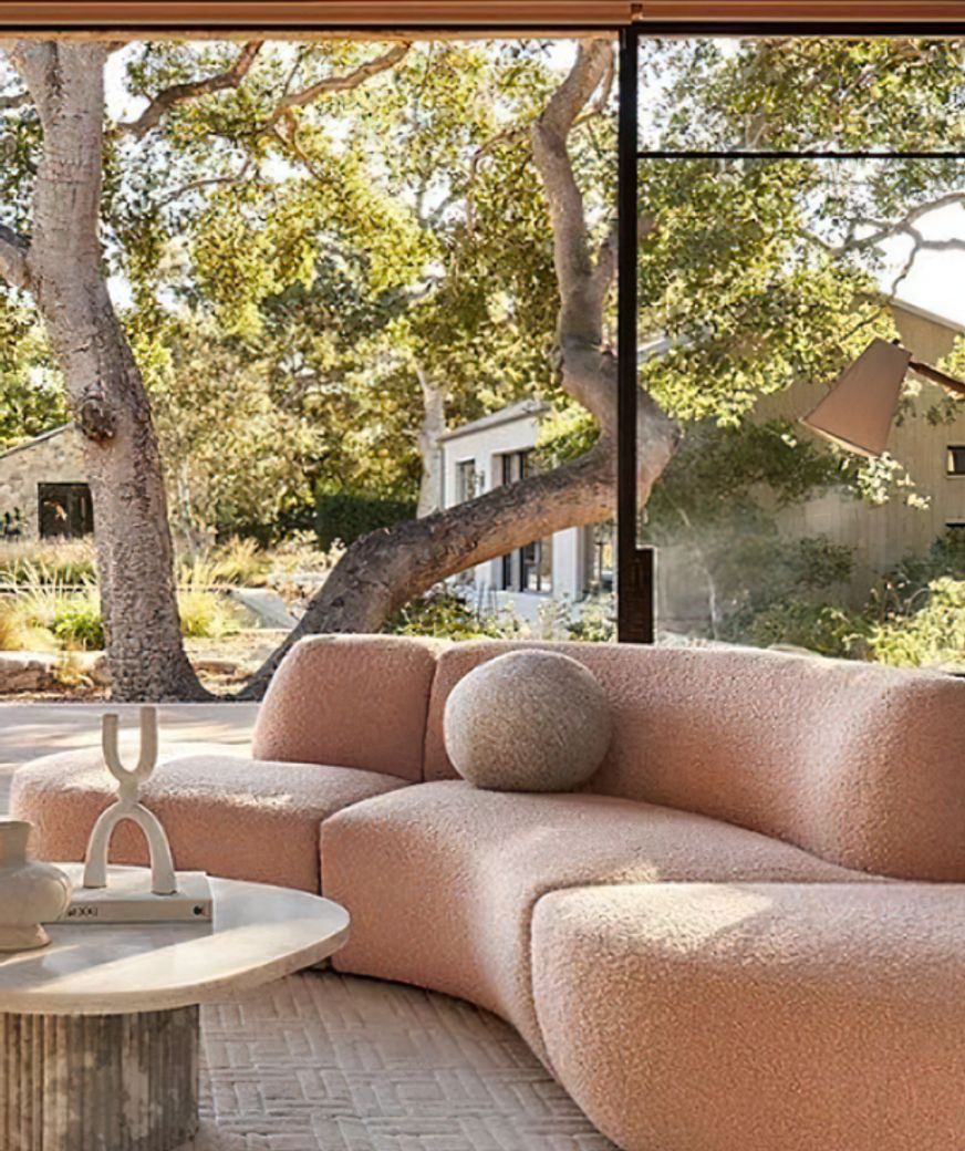 Image Credit: Anthropologie | Curved Sofa in clay tones + biophilic design