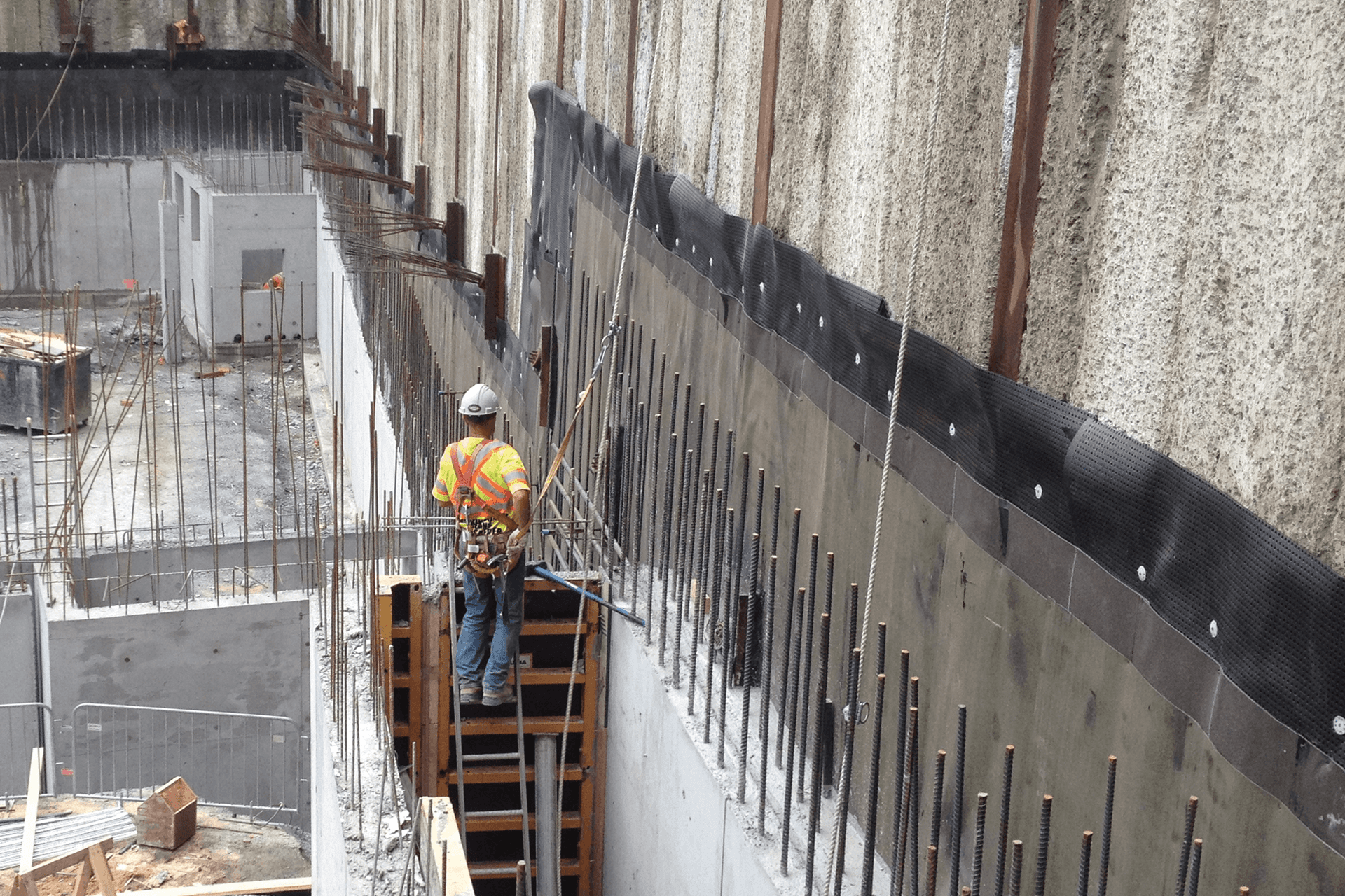 The installation process of underground waterproofing systems.