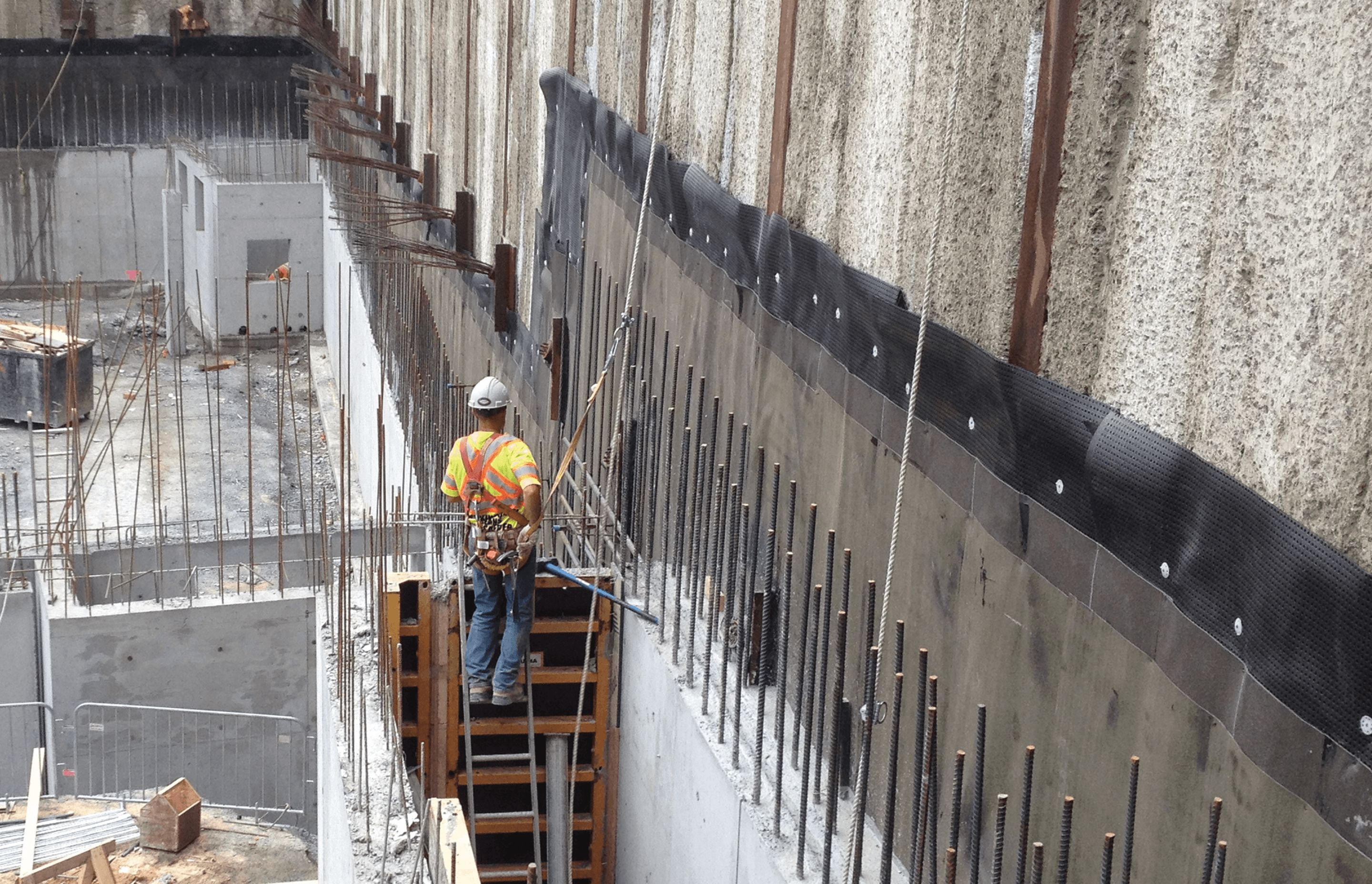 The installation process of underground waterproofing systems.