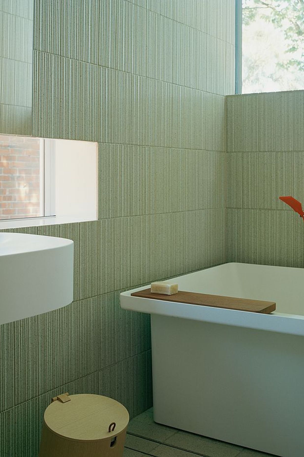 Custom INAX Akai ribbed, bush-hammered and glazed tiles on bathroom wall with INAX Akai ribbed, bush-hammered, glazed and sandblasted tiles on bathroom floor. Kew Residence by John Wardle Architects