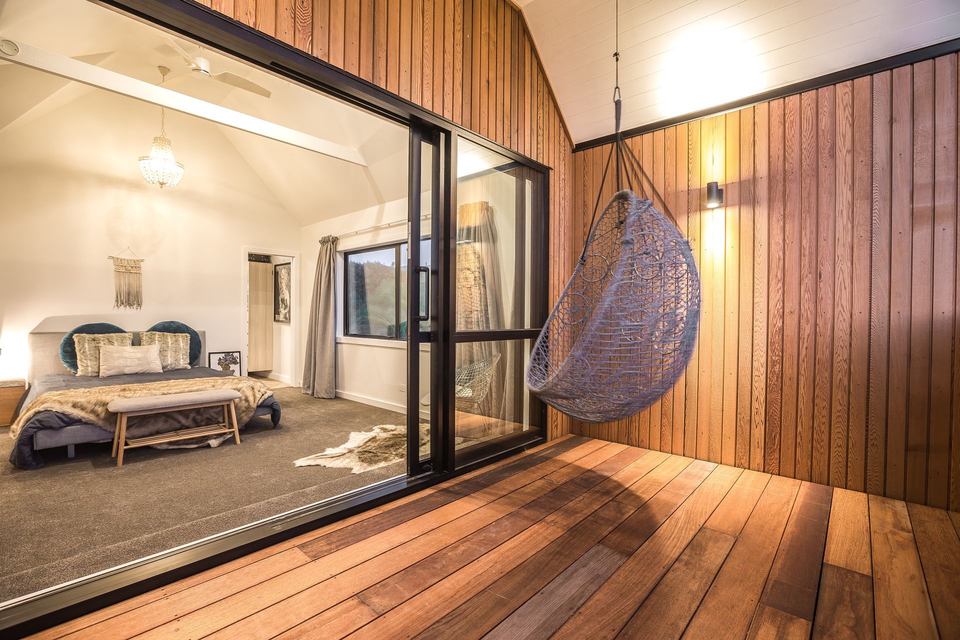 The deck off the master bedroom. Tony and Katie closed in what was previously a metal handrail, extended the roofline overhead and added the hanging chair. “It’s a simple, private getaway spot,” says Tony.