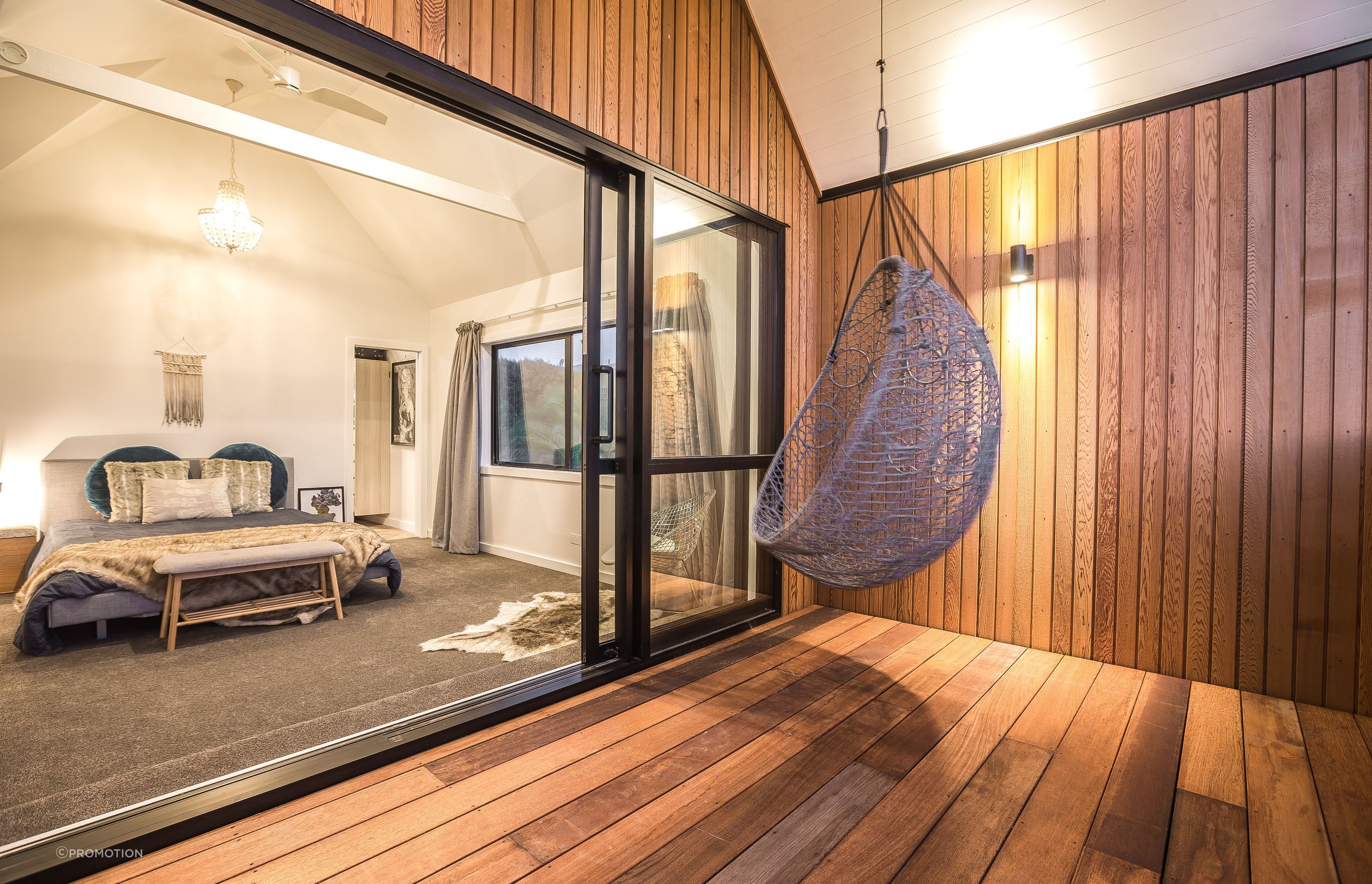 The deck off the master bedroom. Tony and Katie closed in what was previously a metal handrail, extended the roofline overhead and added the hanging chair. “It’s a simple, private getaway spot,” says Tony.