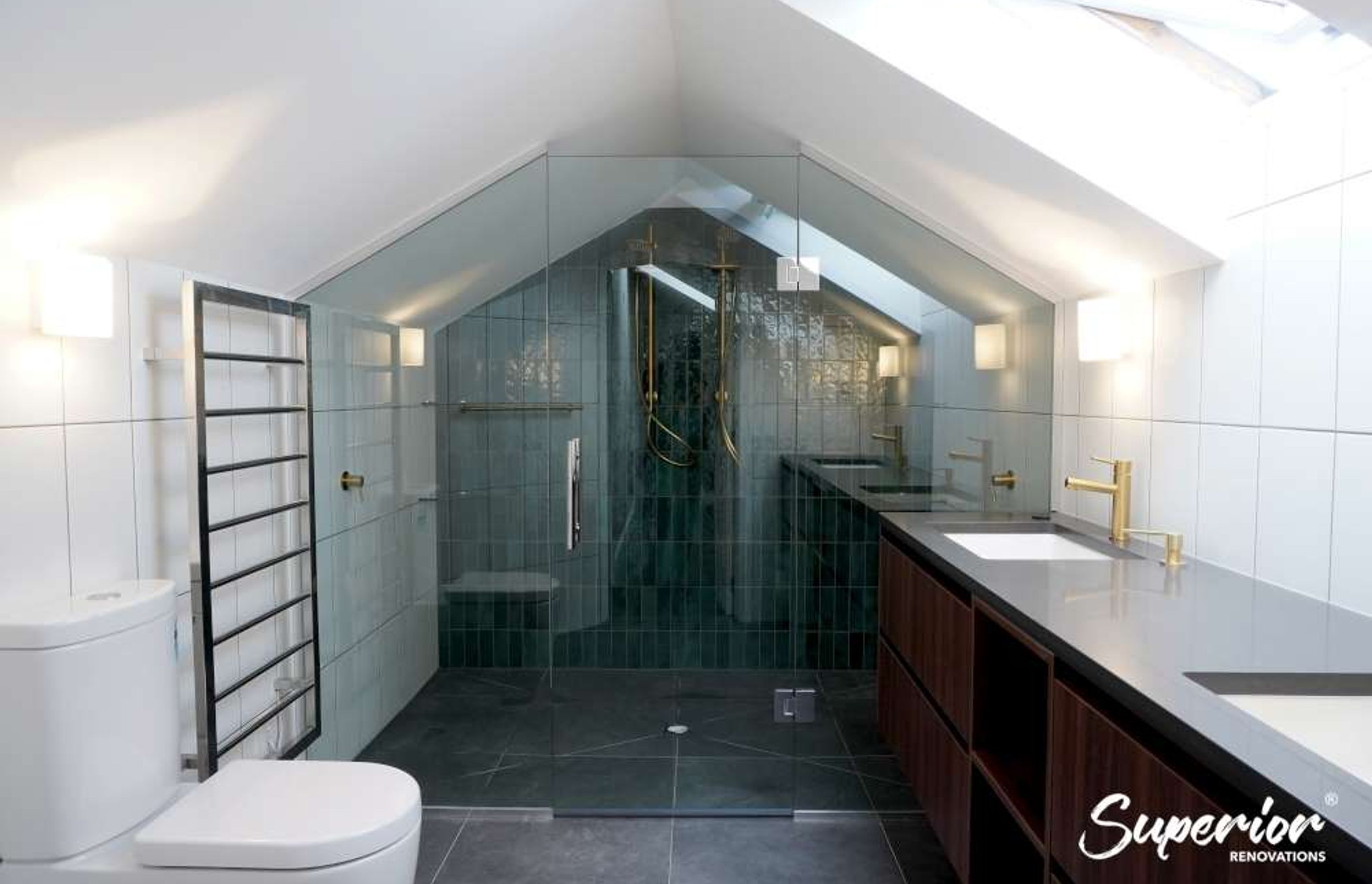 Spacious shower integrated in this bathroom design for a renovation in Westmere