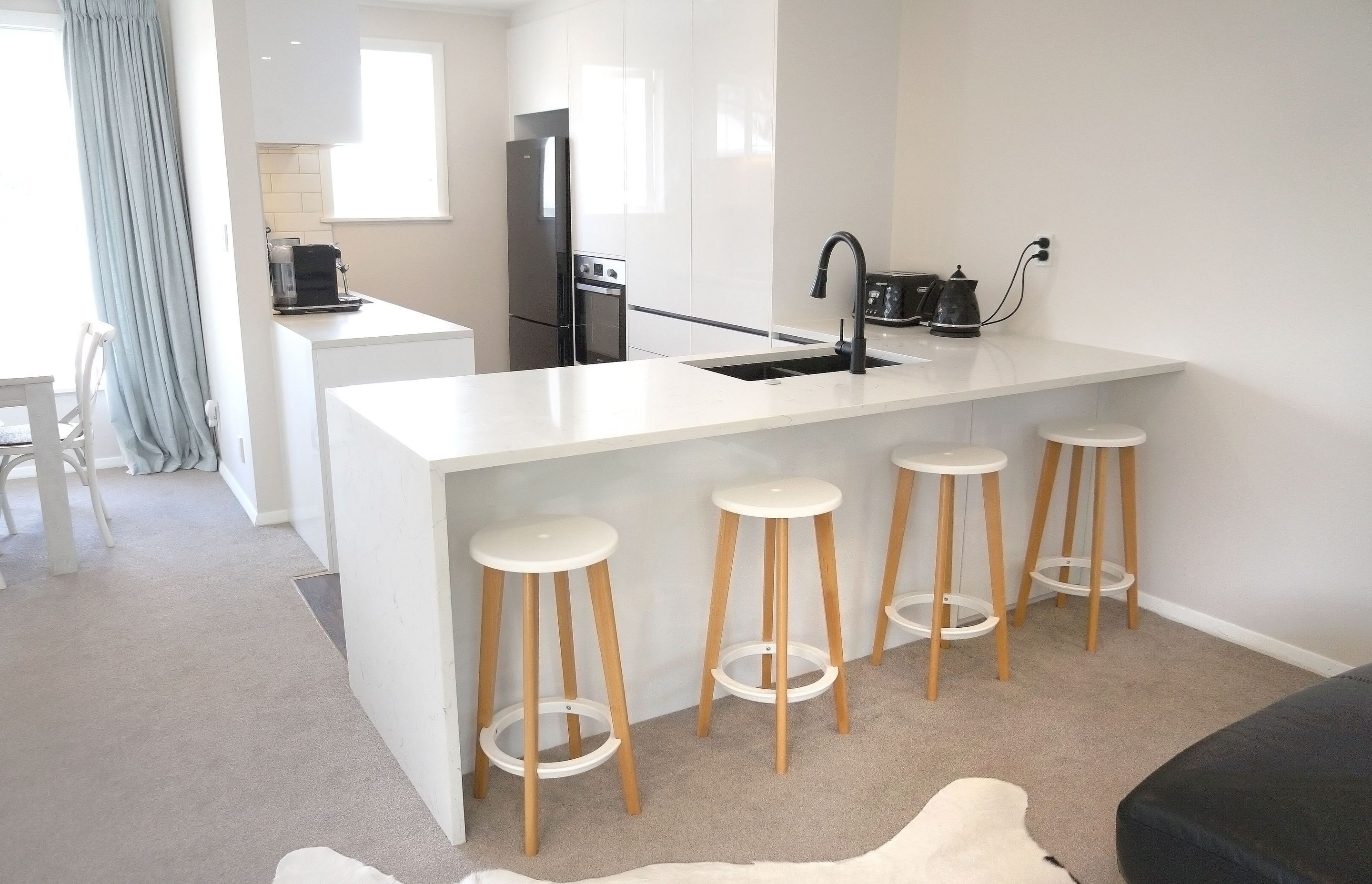 AFTER we demolished the wall we were able to create a small island which gave our clients additional storage, counter space and an area to install their sink