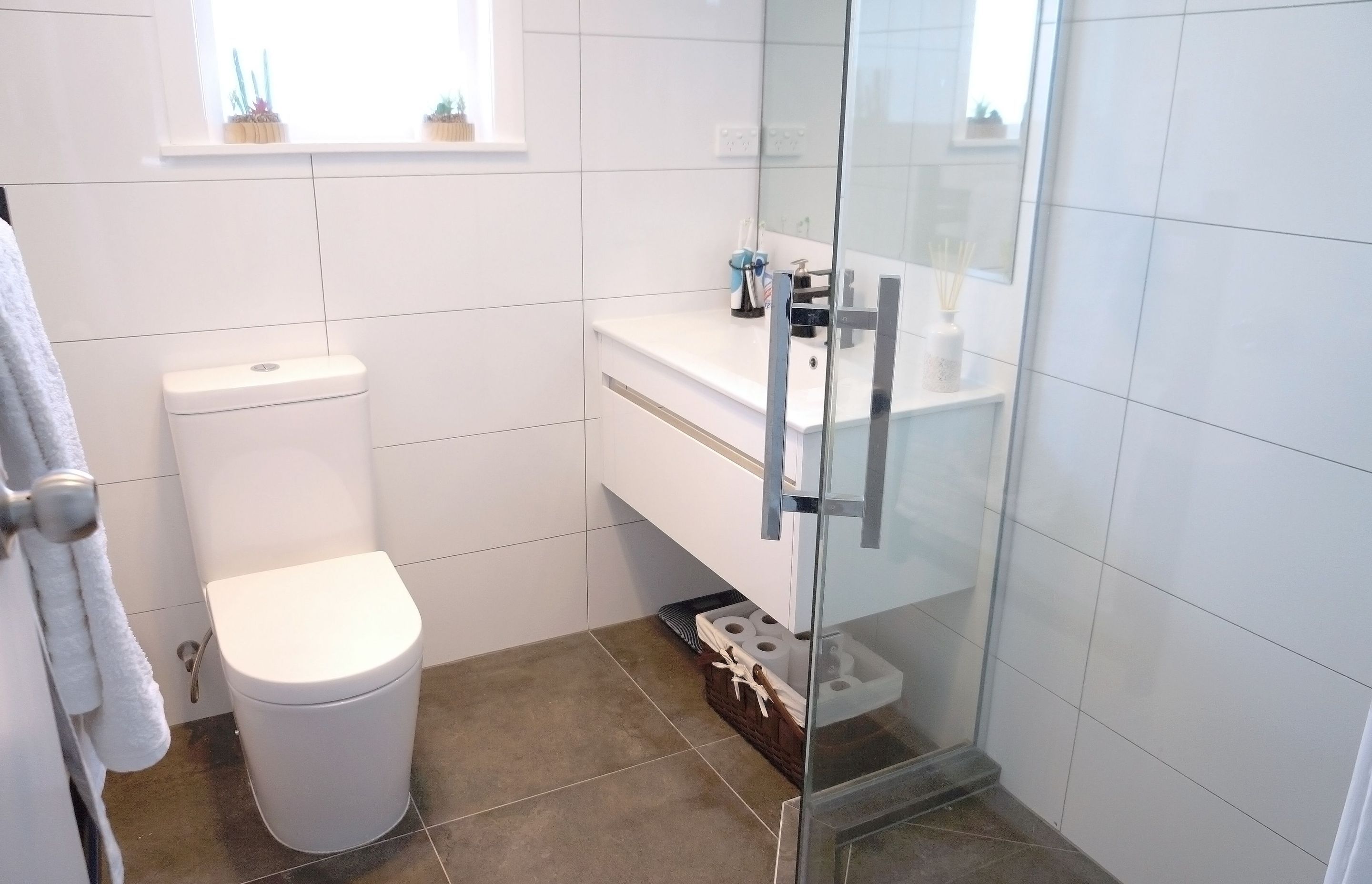 600 by 600 light brown tiles were installed on the floor and white tiles were installed on the walls for a nice contrast in this small bathroom renovation of Greenlane, Auckland