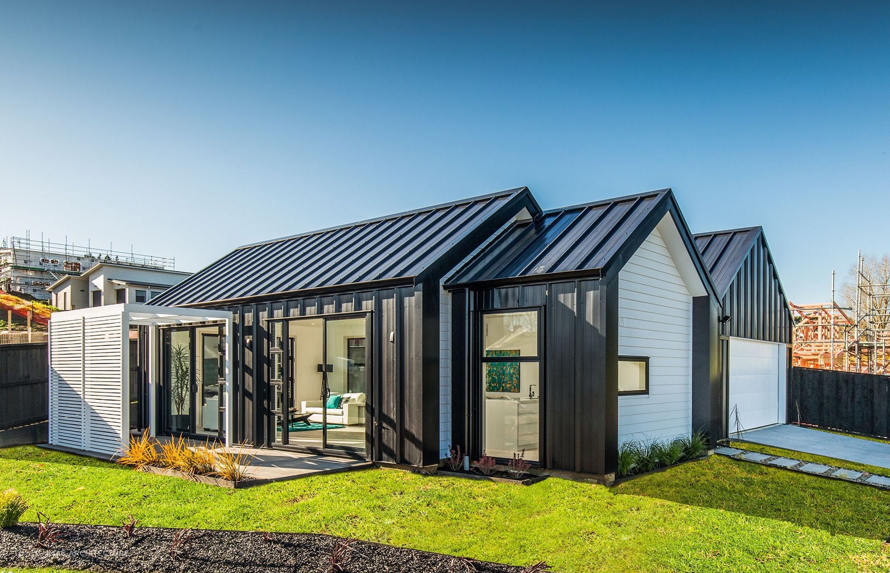 The contrast of black Solar-Rib cladding and white is a simple yet powerful design.