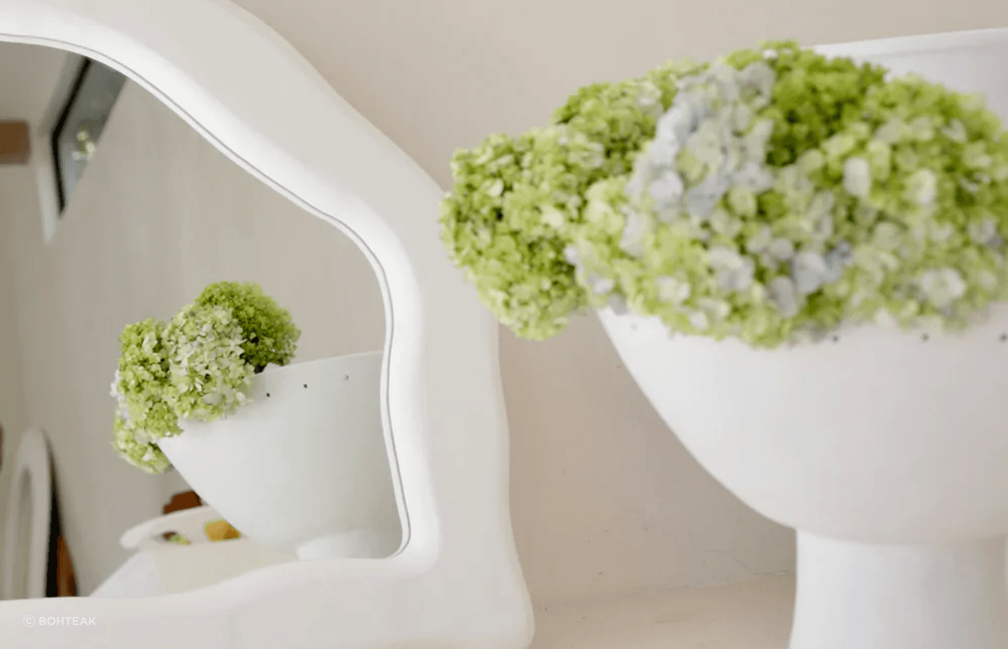 Nature is a complement to itself when used with the right mirror, seen here with the organically shaped Ocean Mirror