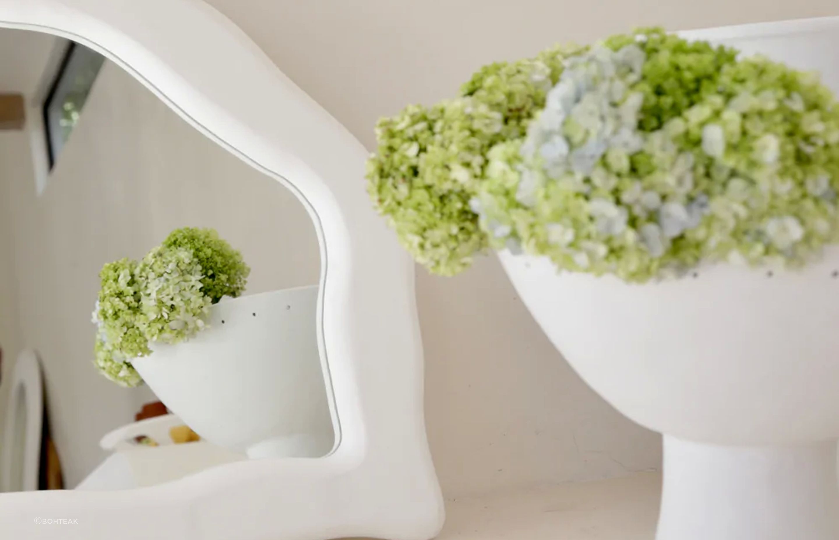 Nature is a complement to itself when used with the right mirror, seen here with the organically shaped Ocean Mirror