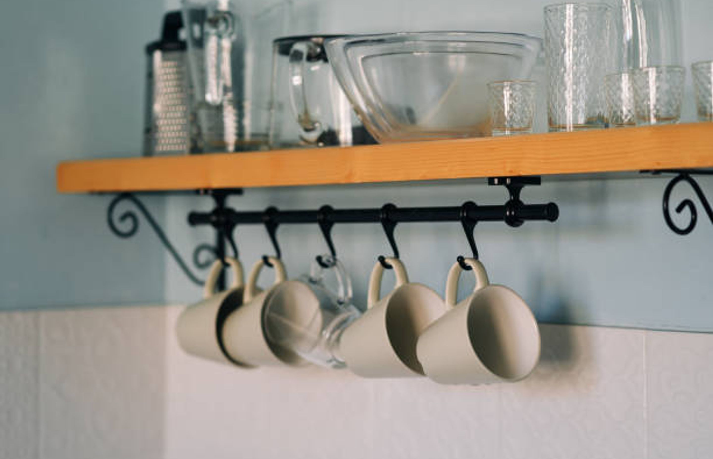 Cup hooks underneath a shelf | Photo Credit – iStock
