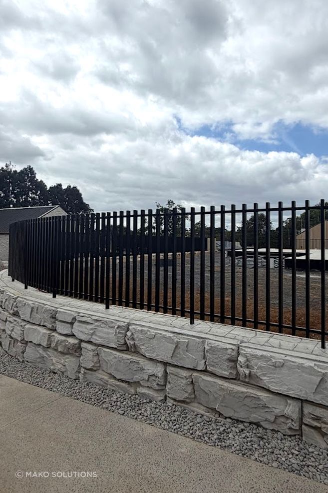 mako-blade-retaining-wall-fixed-into-pavers-auckland-aluminium-fencing-black.jpg