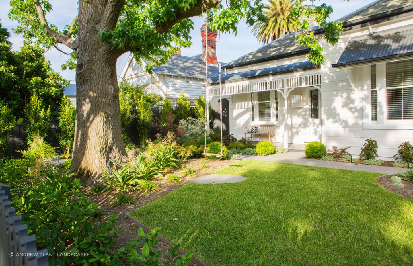 A simple swing adds a nice touch to this front garden