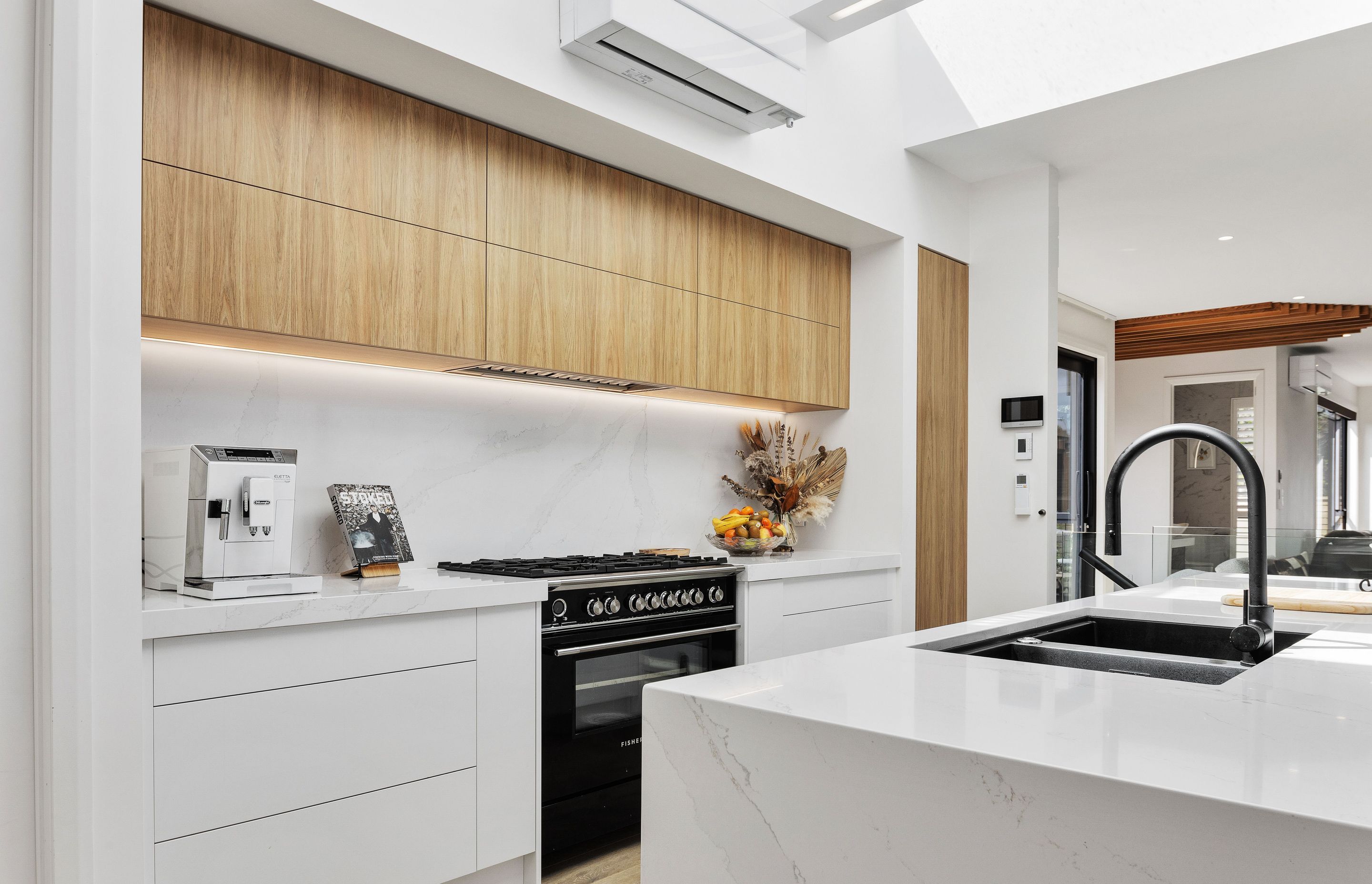 The kitchen is flooded with natural light from the skylights overhead.